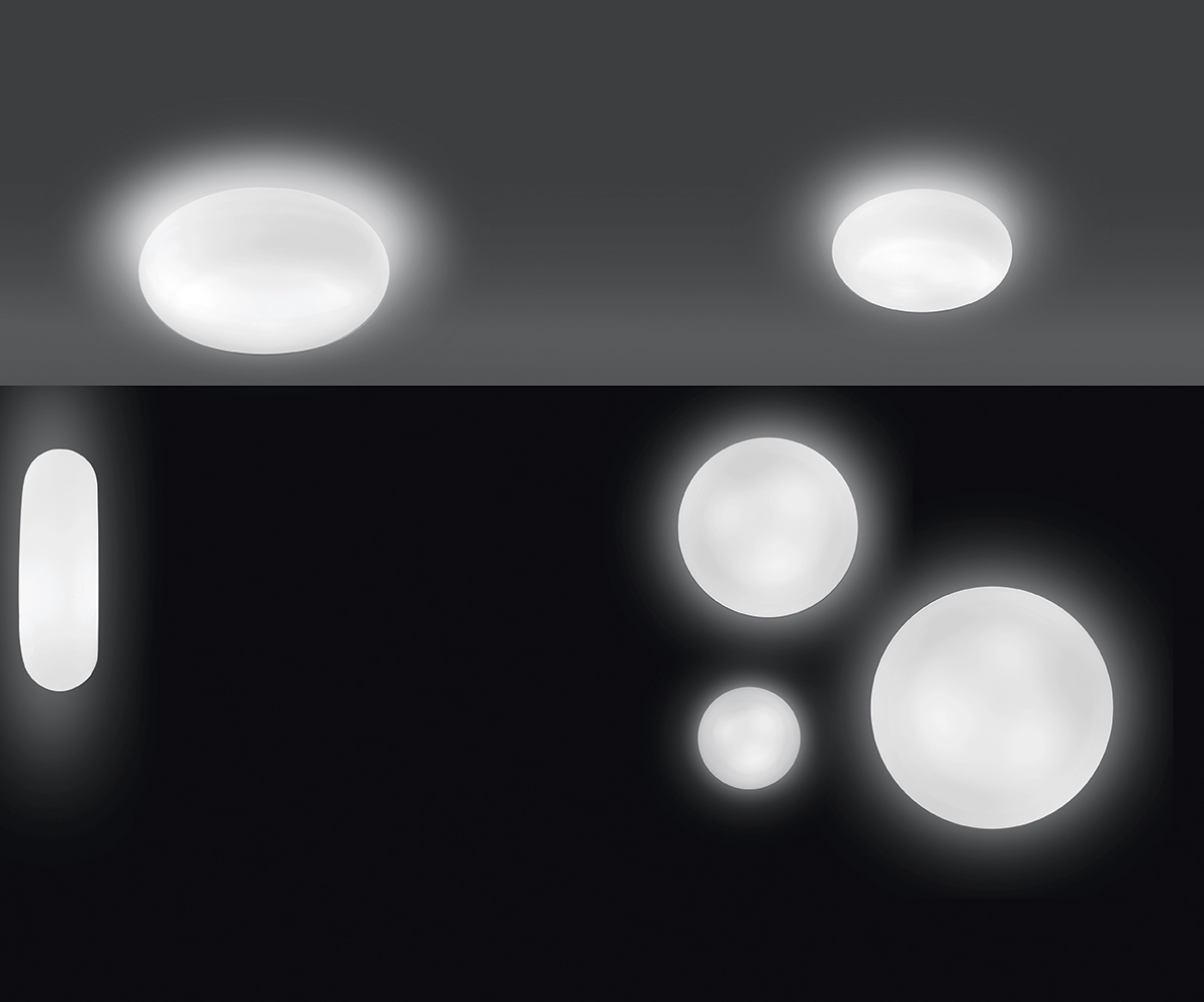 Weiße Itka Wand- und Deckenleuchten von Artemide in verschiedenen Größen und Formen im beleuchteten Zustand.