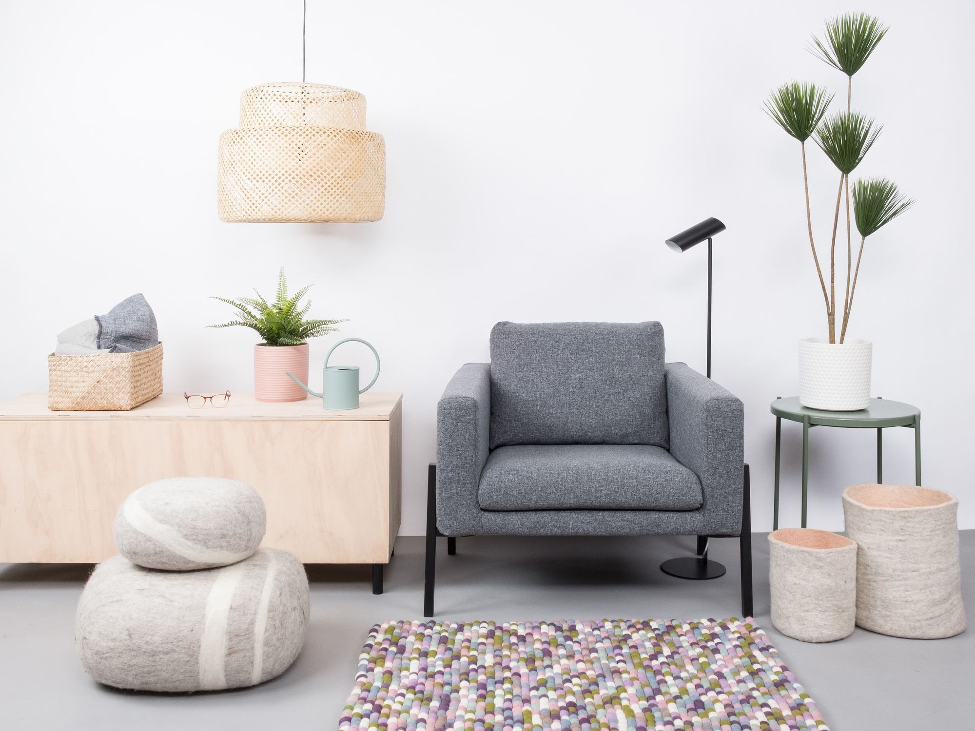 Myfelt Fritz Filzkugel Teppich 160x230 cm im Wohnzimmer mit Sessel und Dekoration.