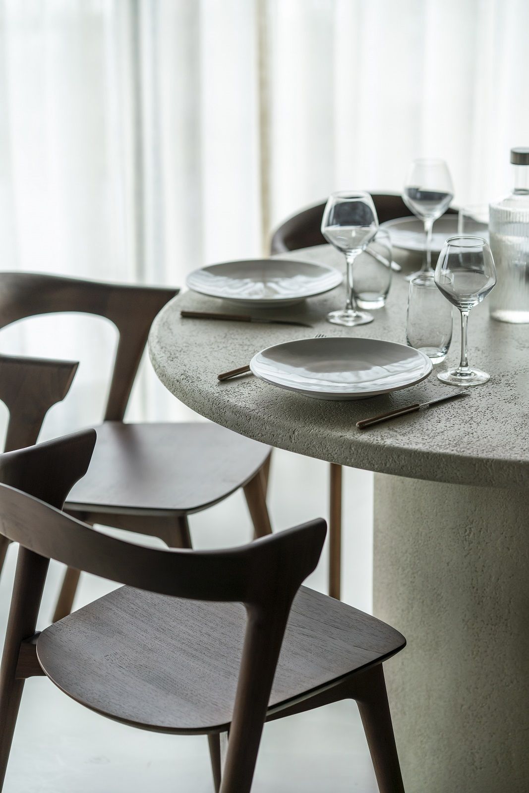 Elements Dining Table Esstisch Rund von Ethnicraft mit Gedeck und Stühlen im modernen Esszimmer.