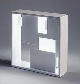 Weiße Fato Tischleuchte von Artemide mit geometrischen Formen und hellem Lichtschein. Design Lampe.
