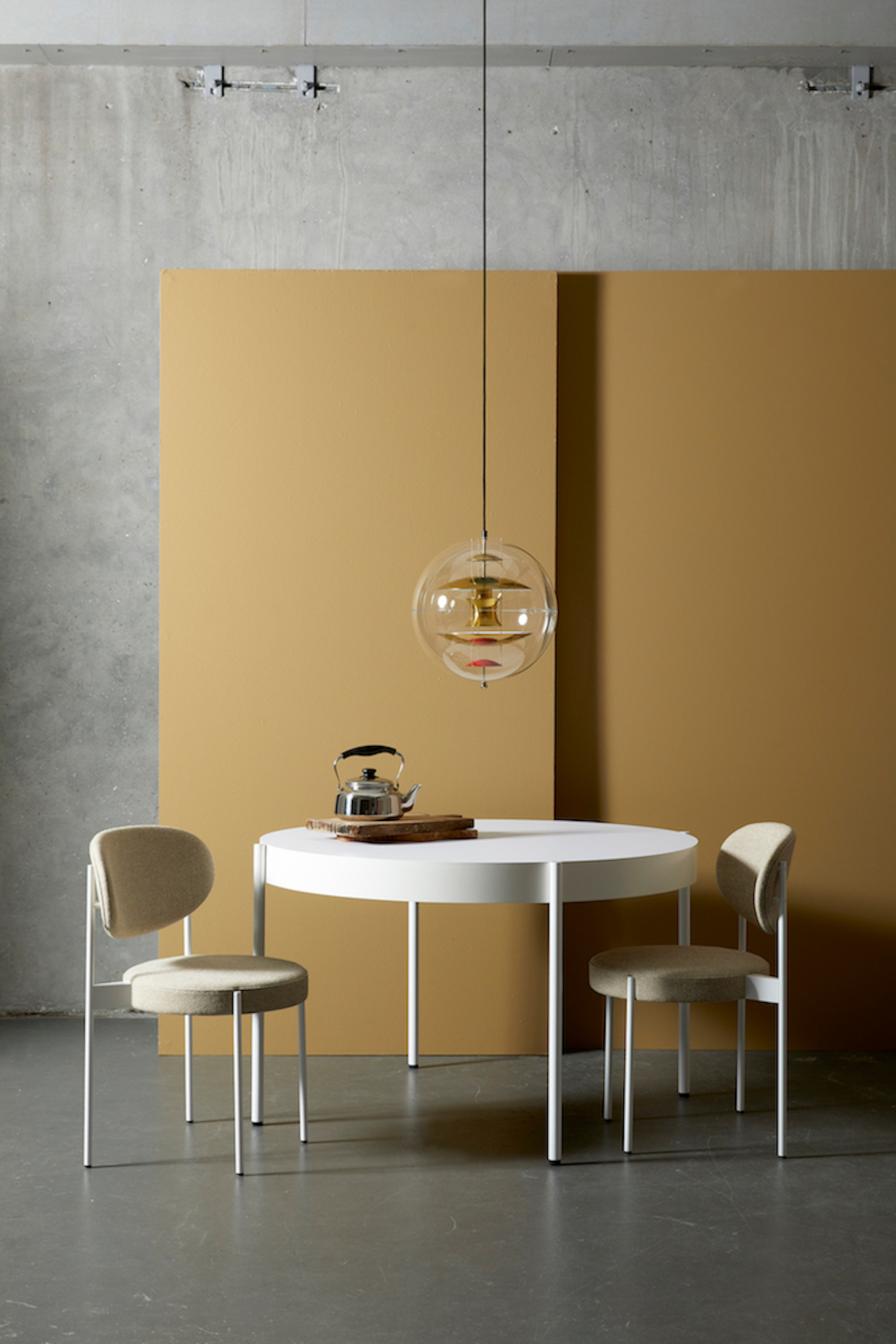 VP Globe Pendelleuchte von Verpan über Esstisch mit Teekessel und zwei Stühlen.