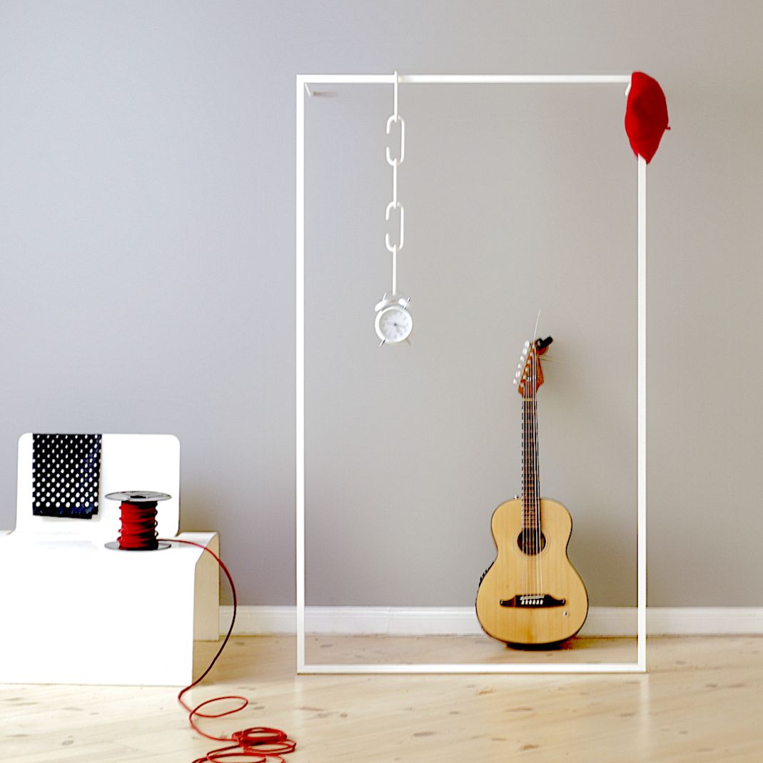 Weiße Leano Anlehngarderobe von Roomsafari mit Gitarre, rotem Tuch und Dekorationen im minimalistischen Design.