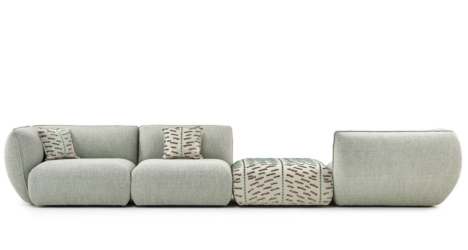 Mia Modulares Sofa von Freifrau Manufaktur: Kombinationsvorschlag mit grauem Stoff und gemusterten Kissen.