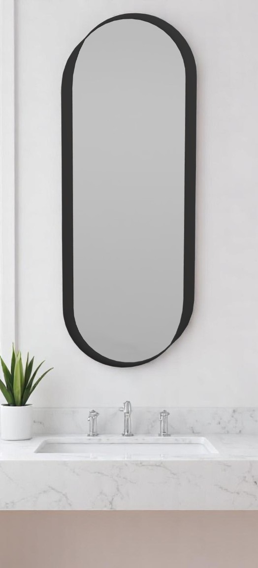 Kimo Wandspiegel von Schönbuch, oval mit schwarzem Rahmen, über einem Waschbecken im Badezimmer.