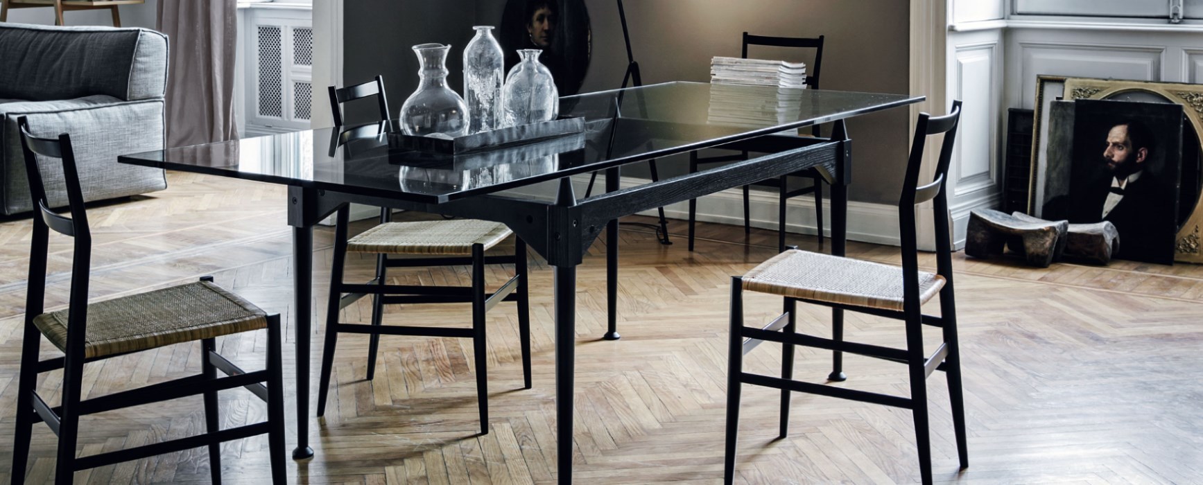 Esszimmer mit schwarzem Tisch und Cassina Superleggera Stühlen mit Wiener Geflecht Sitzfläche.