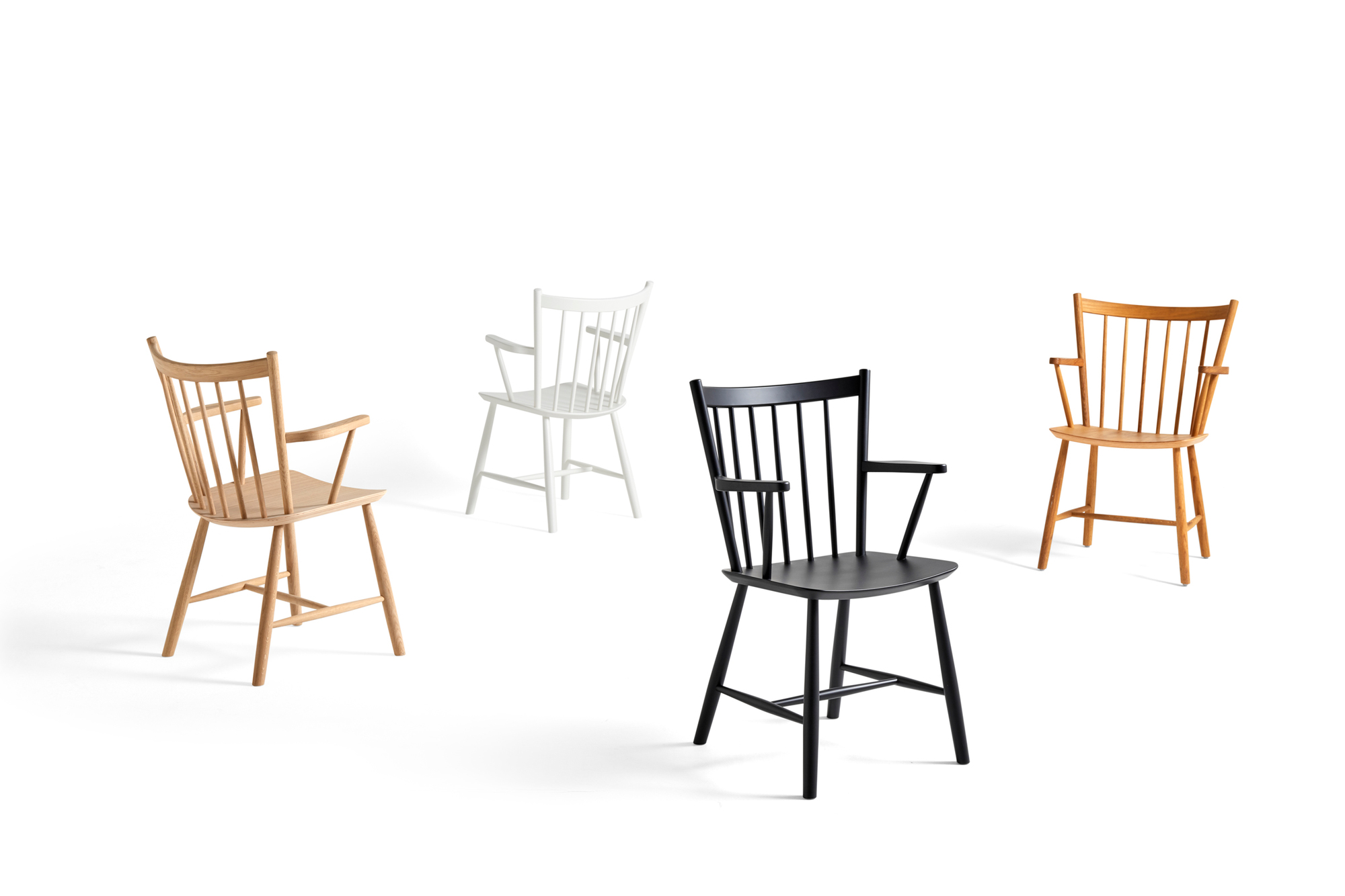 Vier J42 Stühle von Hay in Holz, Weiß, Schwarz und Eiche auf weißem Hintergrund.