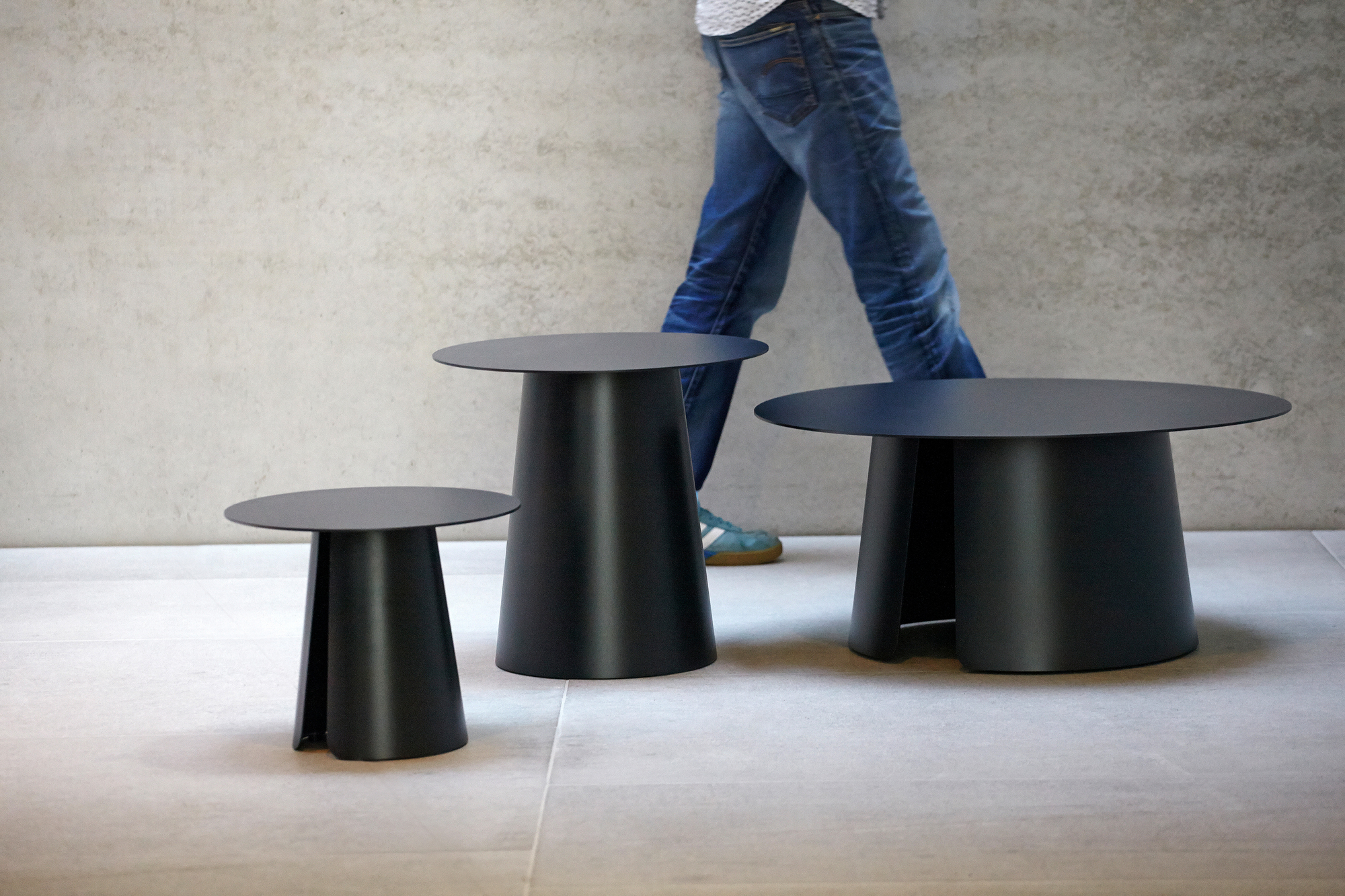 Drei moderne, schwarze Beistelltische mit runder Tischplatte. Design-Tische für Wohnzimmer und Büro.