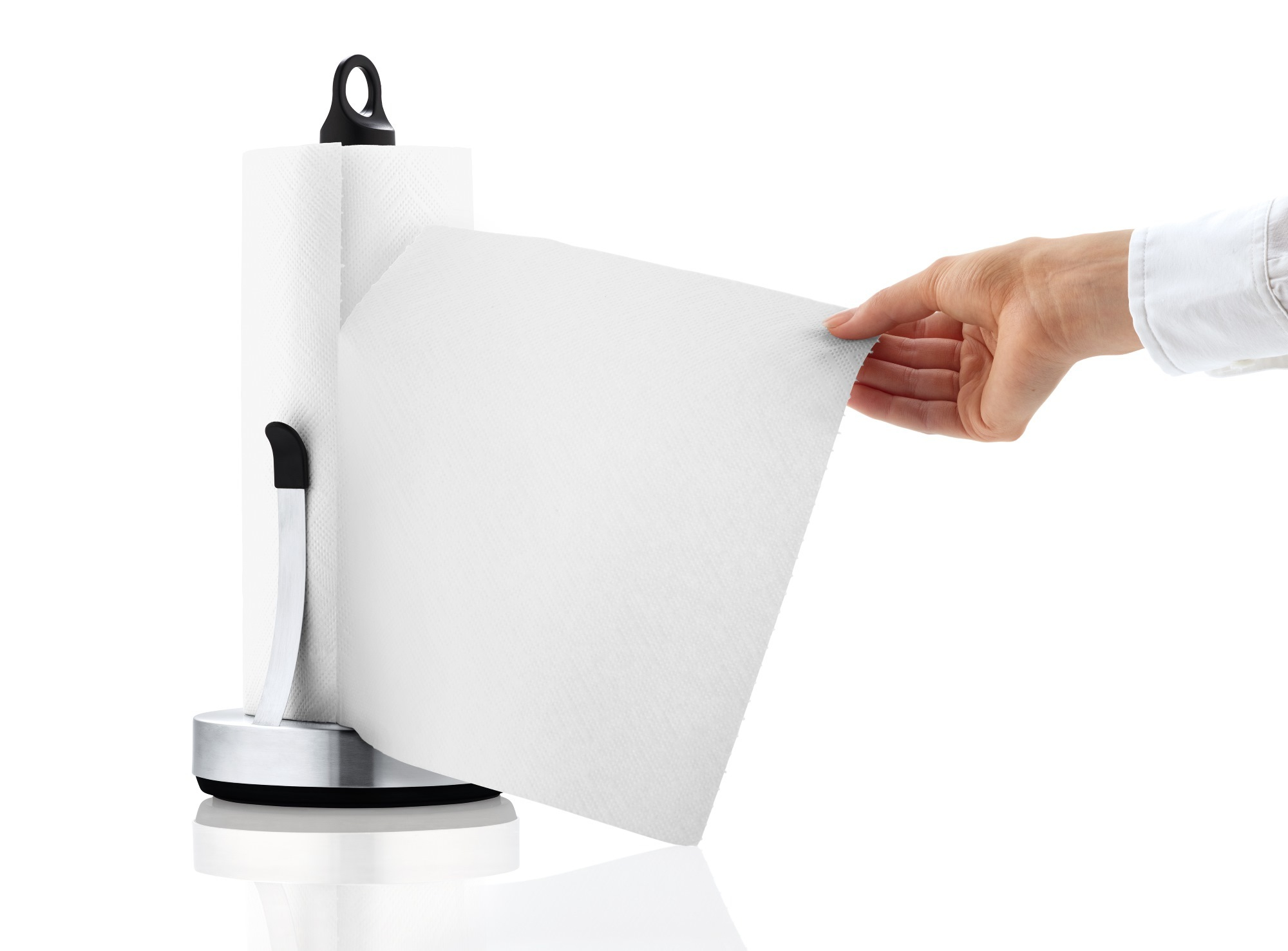 Blomus Loop Küchenrollenhalter: Hand reißt ein Blatt Küchenpapier von der Rolle ab.