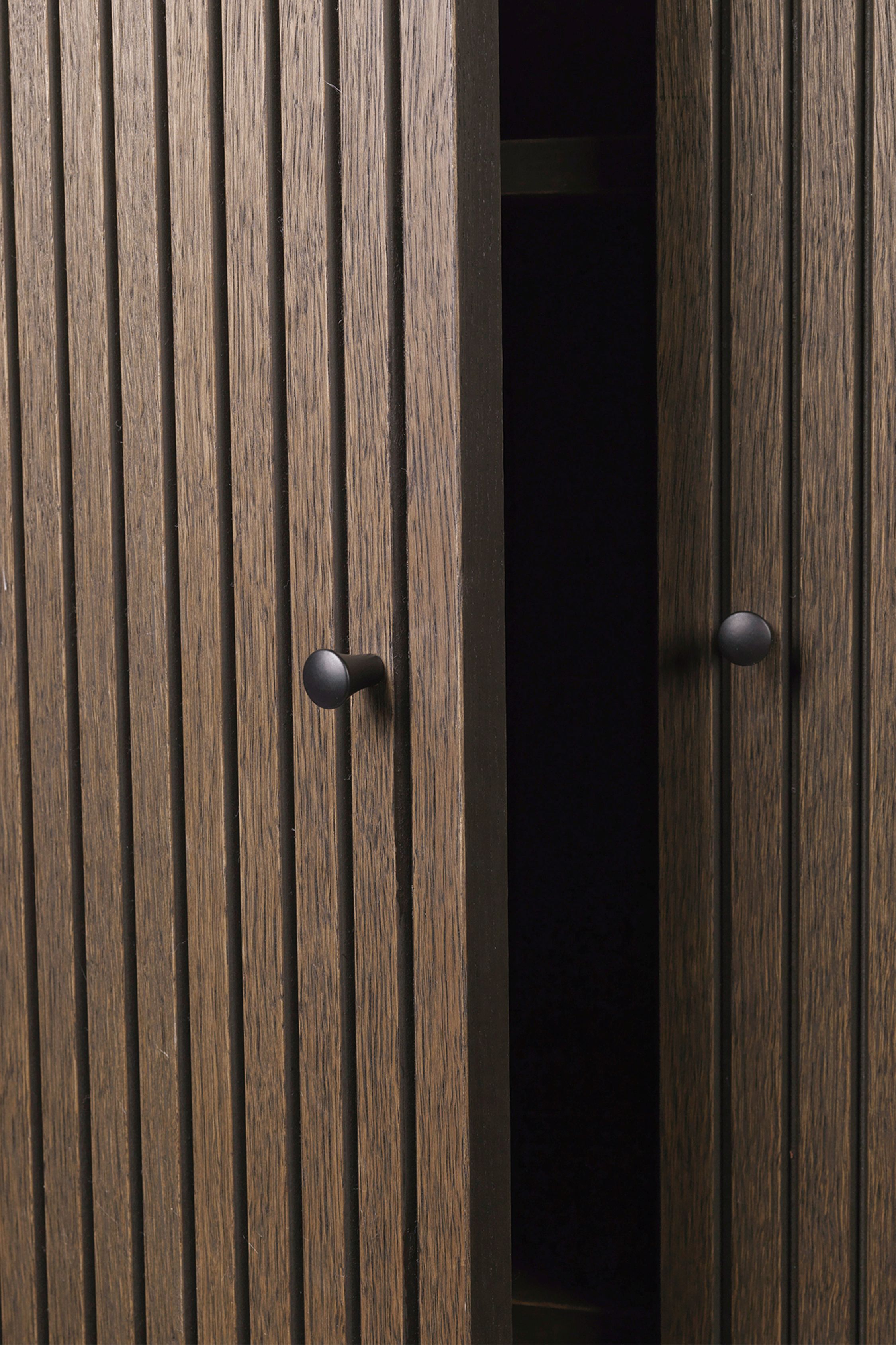 Detailaufnahme des Ferm Living Sill Schrank niedrig in dunkel gebeizter Eiche mit geöffneter Tür.