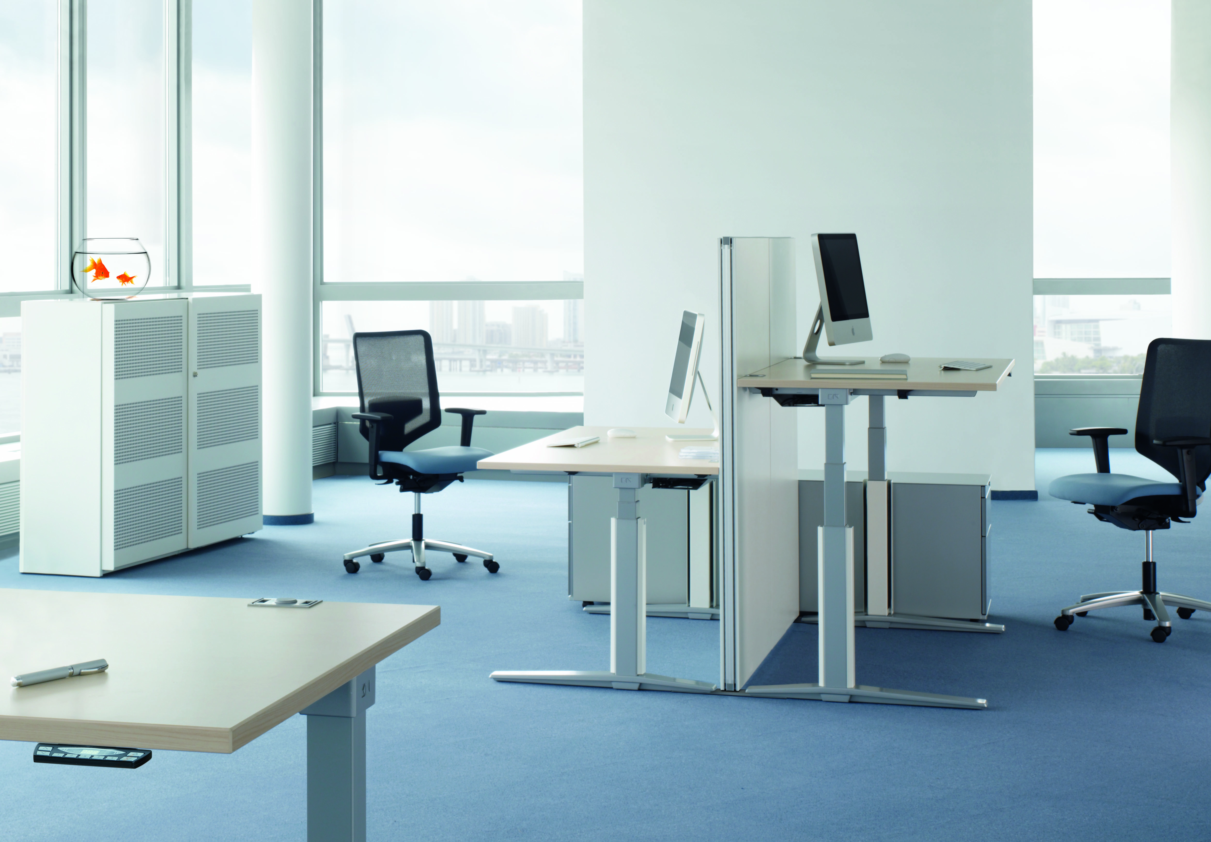 Büro mit höhenverstellbaren Talo.S Konferenztischen von König+Neurath, Bürostühlen, Schränken und Computern in modernem Design.