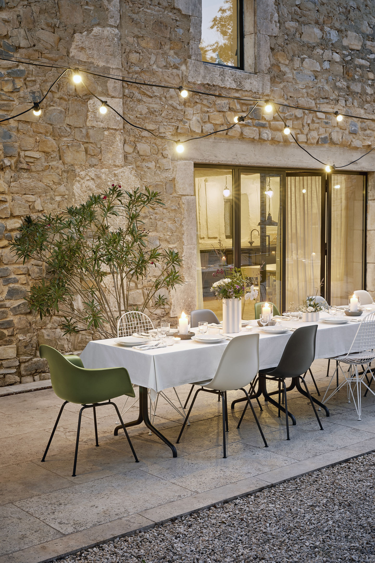 Esstisch im Freien mit Vitra Eames Plastic Arm Chairs DAX und Sitzpolster.