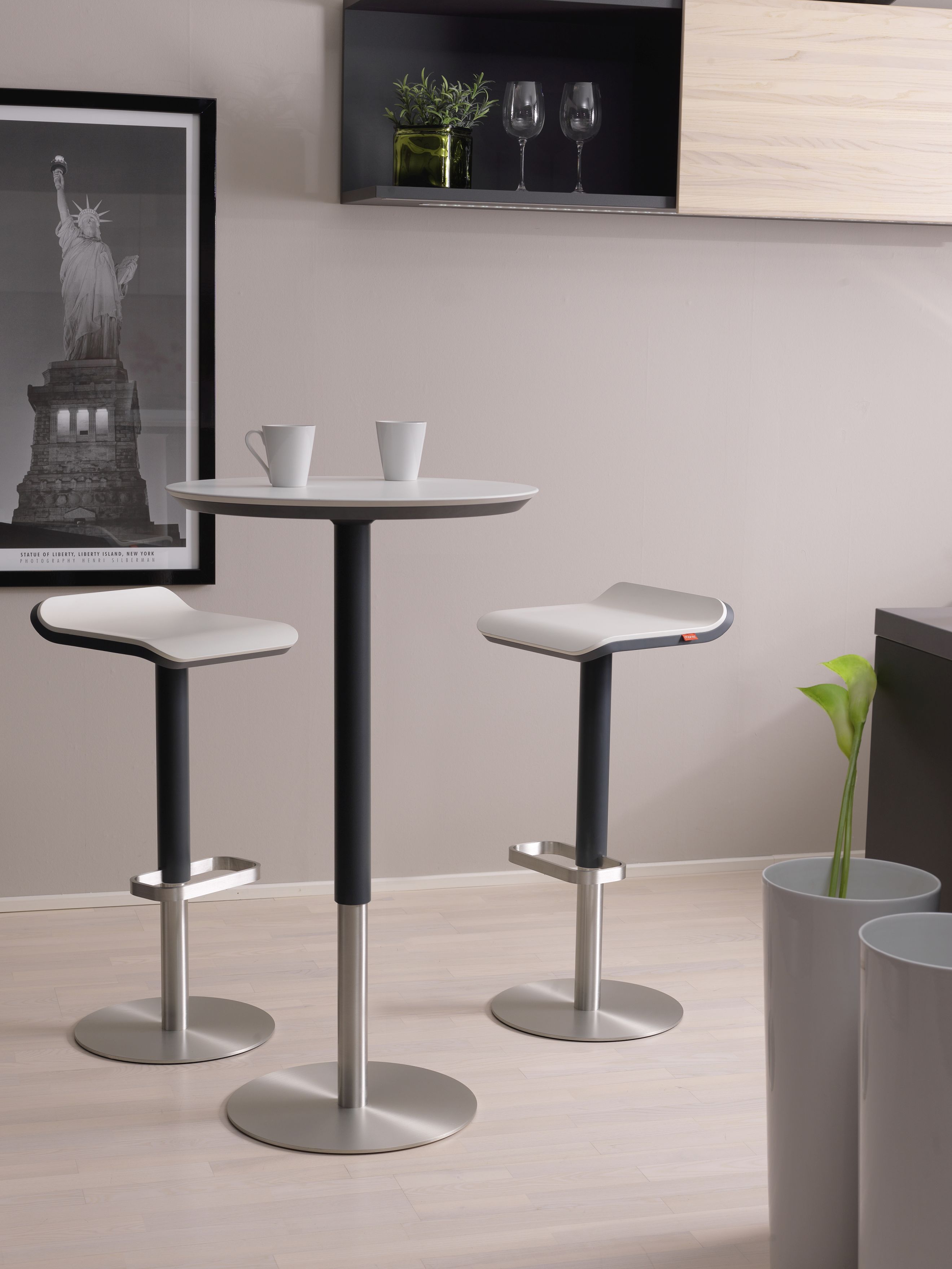 Zwei höhenverstellbare ED Barhocker von Moree an einem Stehtisch, modernes Design für Küche oder Bar.