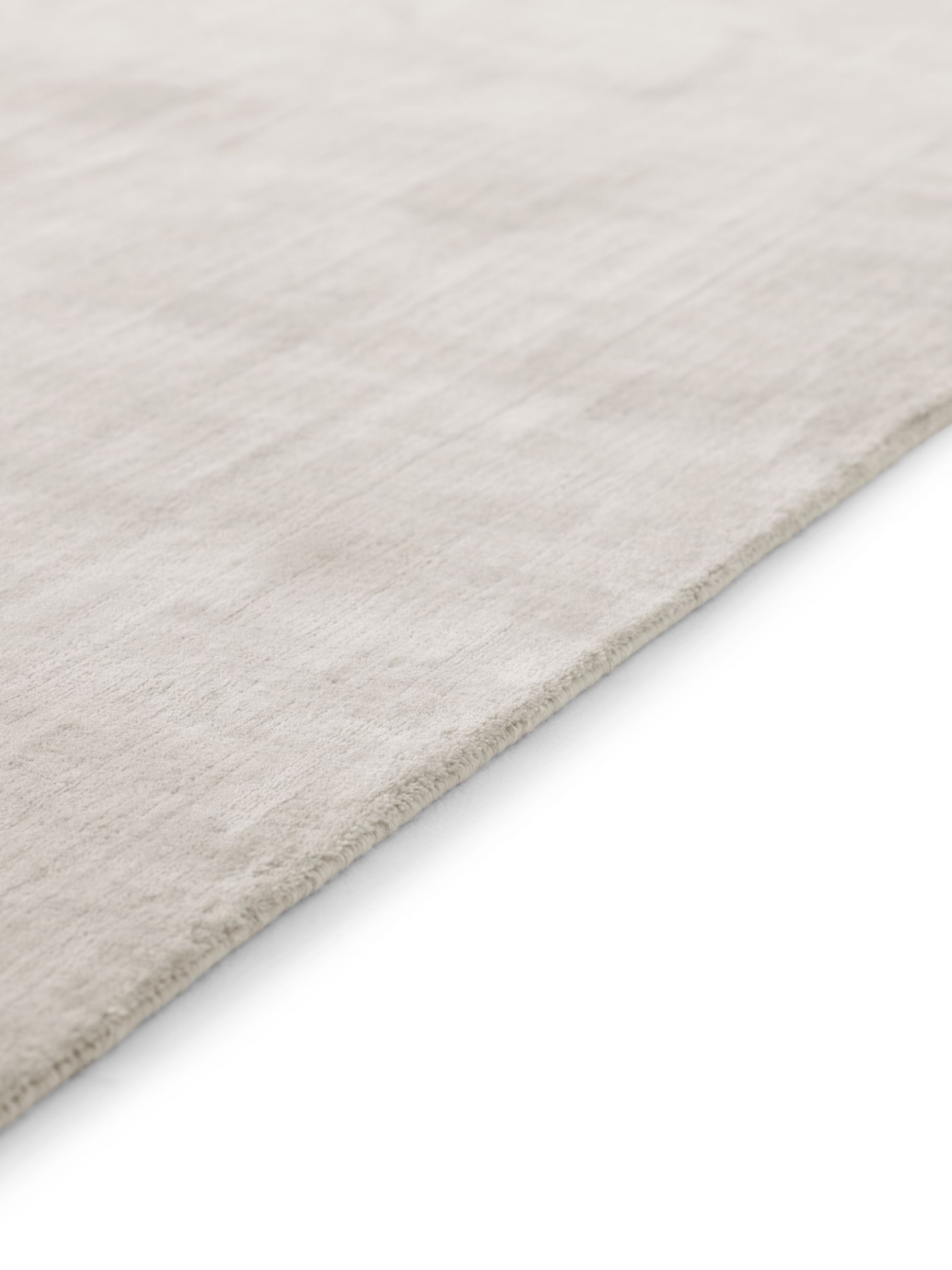 Detailaufnahme des Vipp Wollteppichs (400x300) in Beige, hergestellt aus Wolle und Bambusfasern.