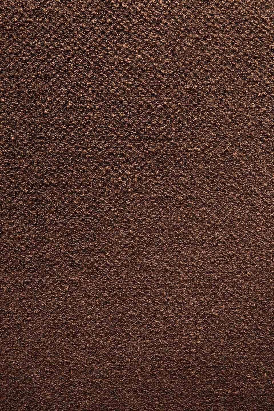 Detailaufnahme des kupferfarbenen Stoffbezugs vom Ethnicraft Barrow Sitzhocker. Gemusterte Textur für Wohnzimmer und mehr.