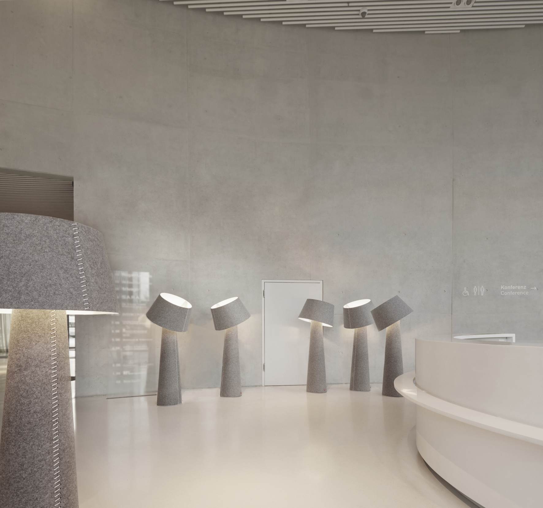 Alice XL Stehleuchte von Moree: Graue Filz-Stehlampen in einem modernen Büro mit Empfangsbereich.