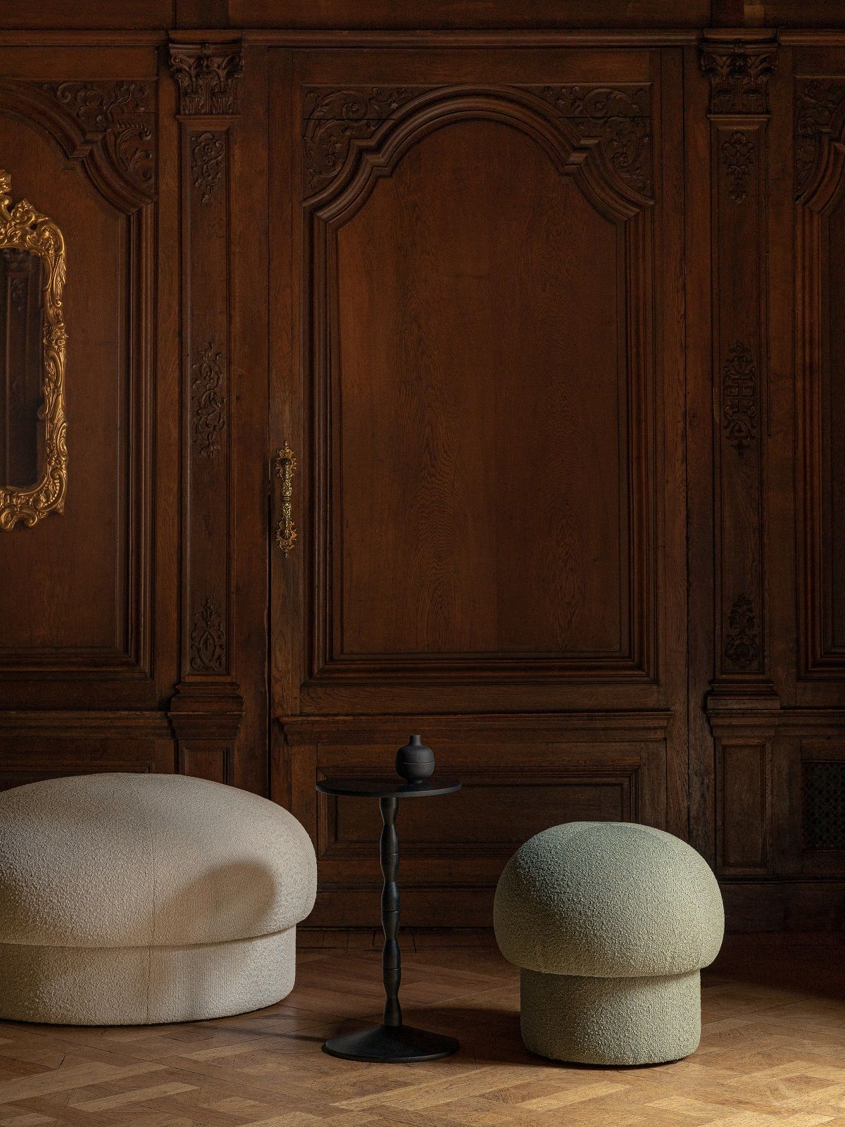 Zwei Uno Pouf Hocker von Design House Stockholm in Beige und Grün vor dunkler Holzvertäfelung.