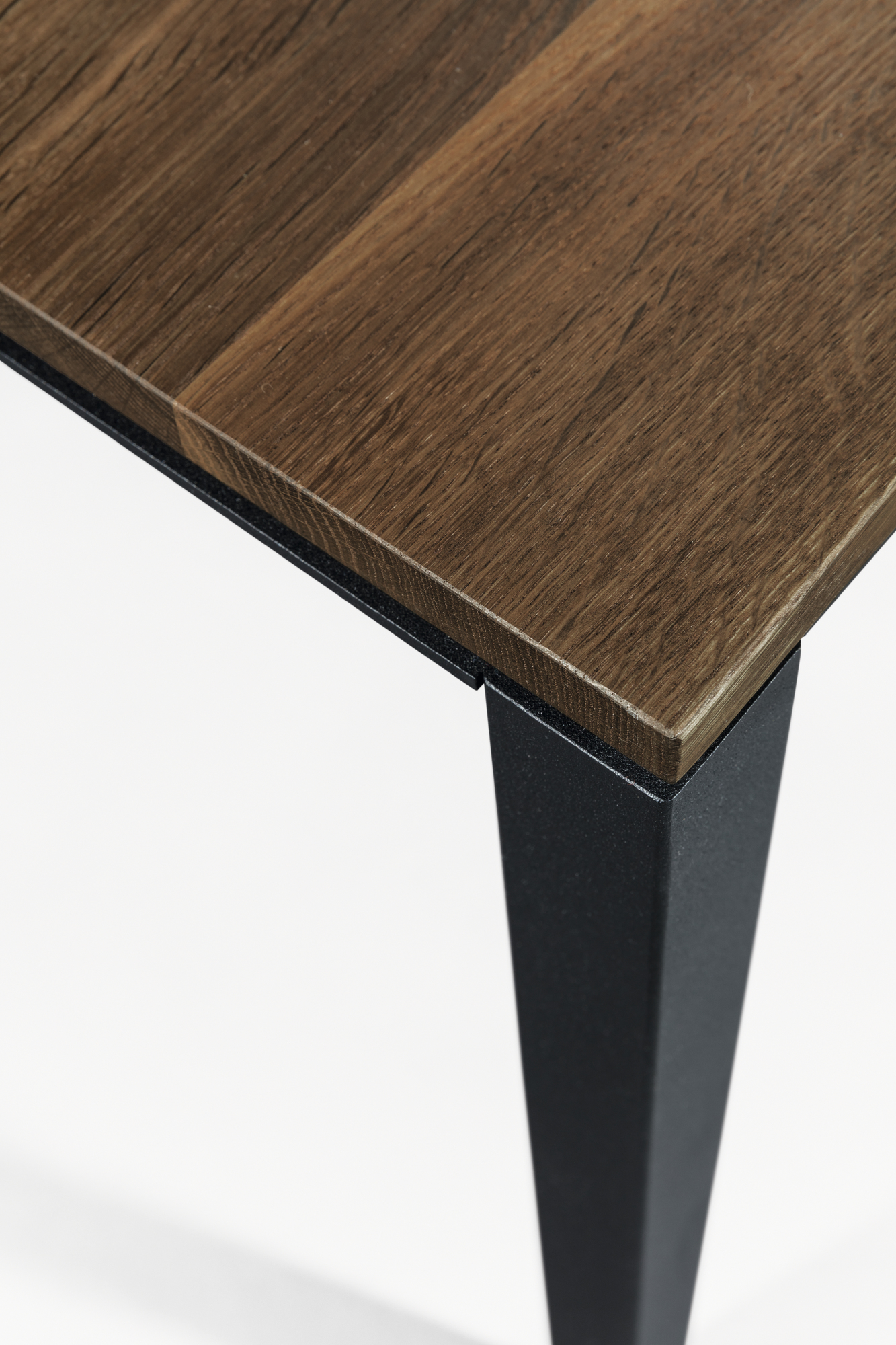 Detailaufnahme: S 600 Tisch mit geräucherter Eichenplatte und schwarzem Metallfuß von Janua.