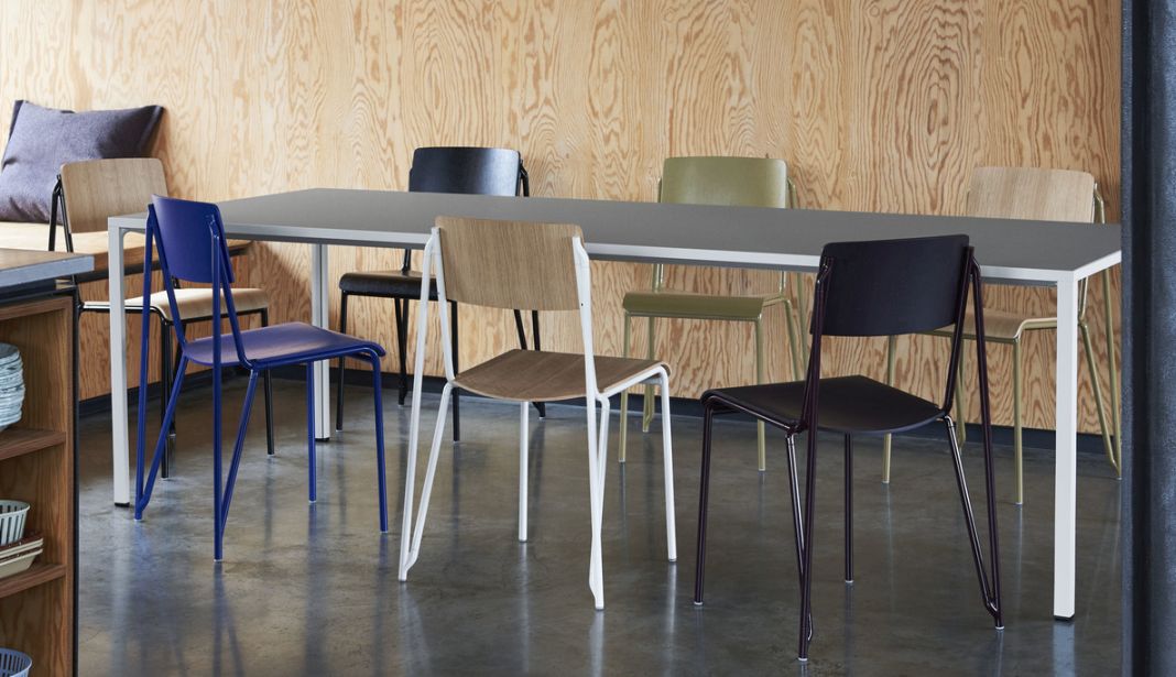 Mehrere Hay Stühle, darunter Petit Standard Stühle, in verschiedenen Farben an einem Esstisch.