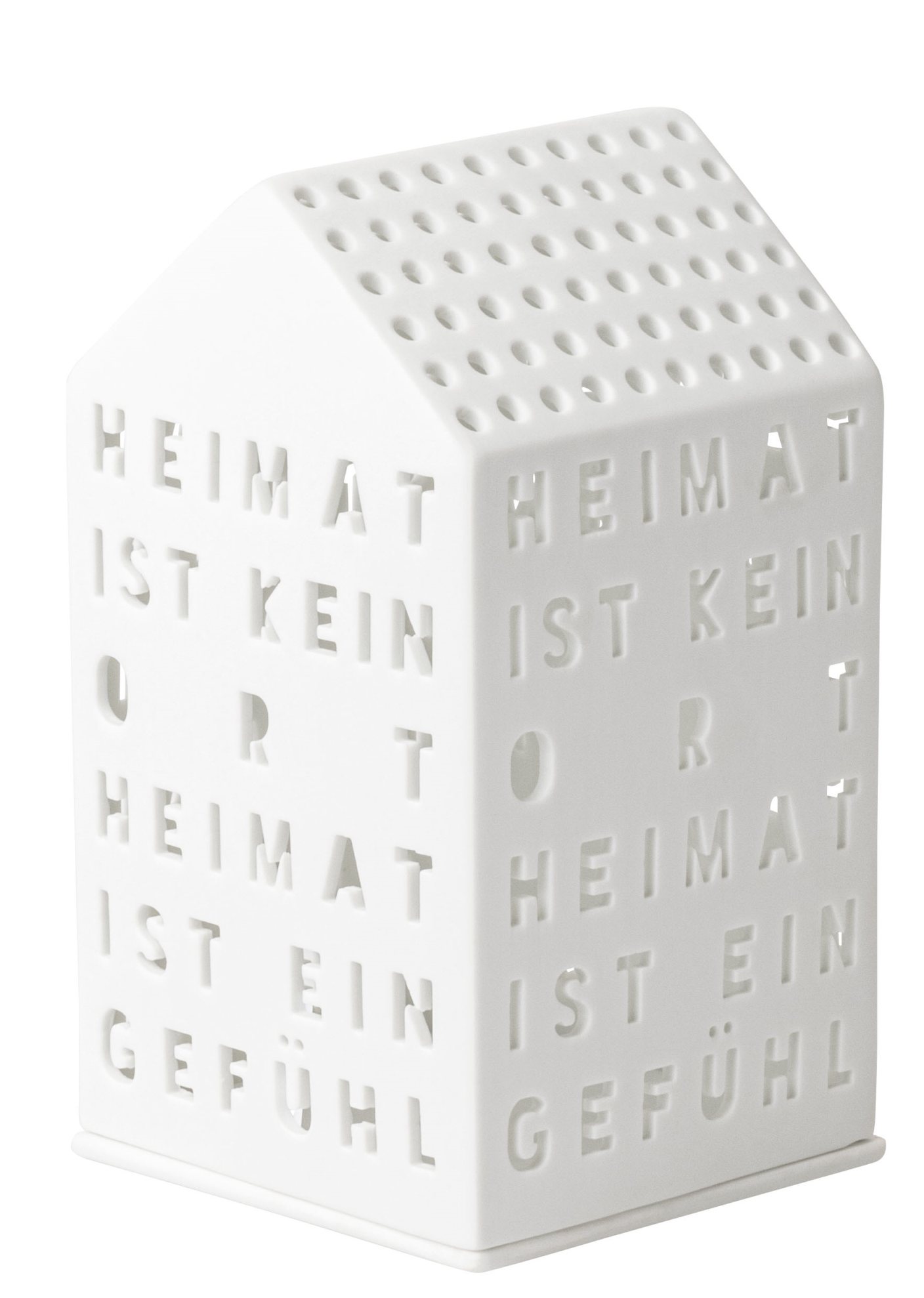 Weißes Lichthaus "Heimat ist kein Ort" von Räder mit Ausstanzungen und Löchern für Teelichter.