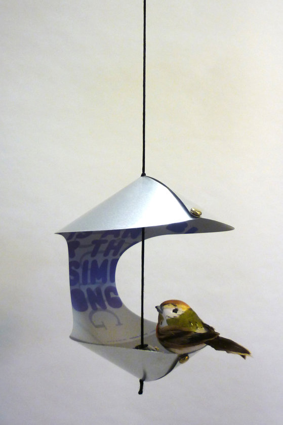 Hängende Vogelstation von Daniel Grimme, modernes Design mit silbernen Elementen und kleinem Vogel darin.