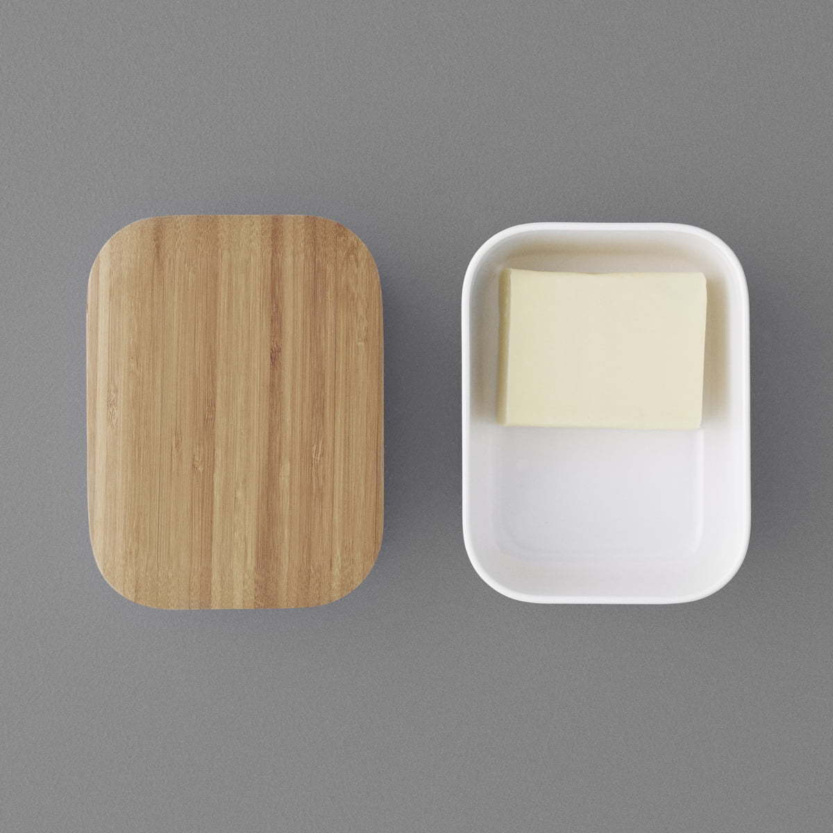 BOX-IT Butterdose von RIG TIG by Stelton mit Bambusdeckel und Butterstück in weißer Dose.