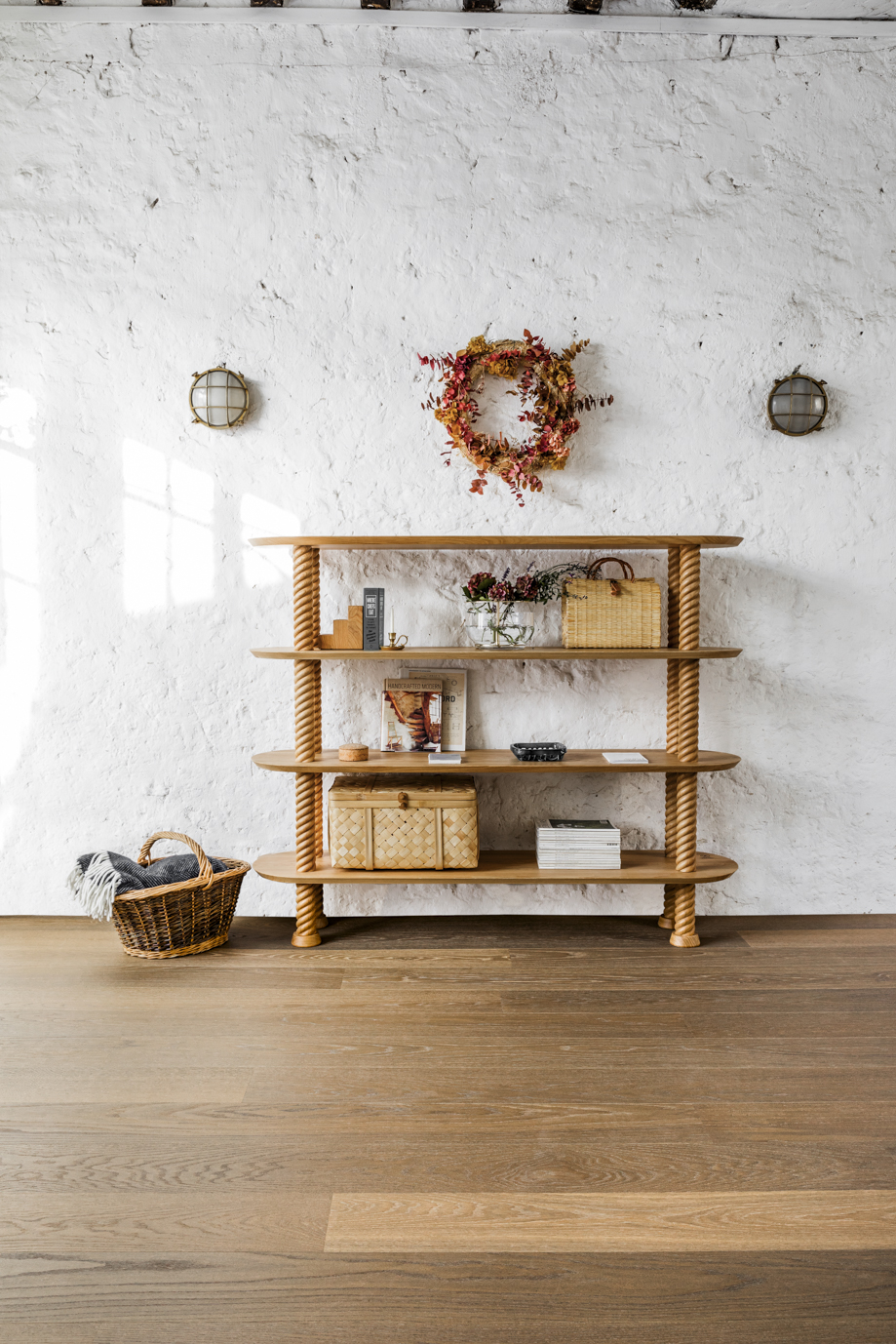 The Hansen Family #80 Rope Shelf: Holzregal mit Seildesign, dekoriert mit Wohnaccessoires vor weißer Wand.