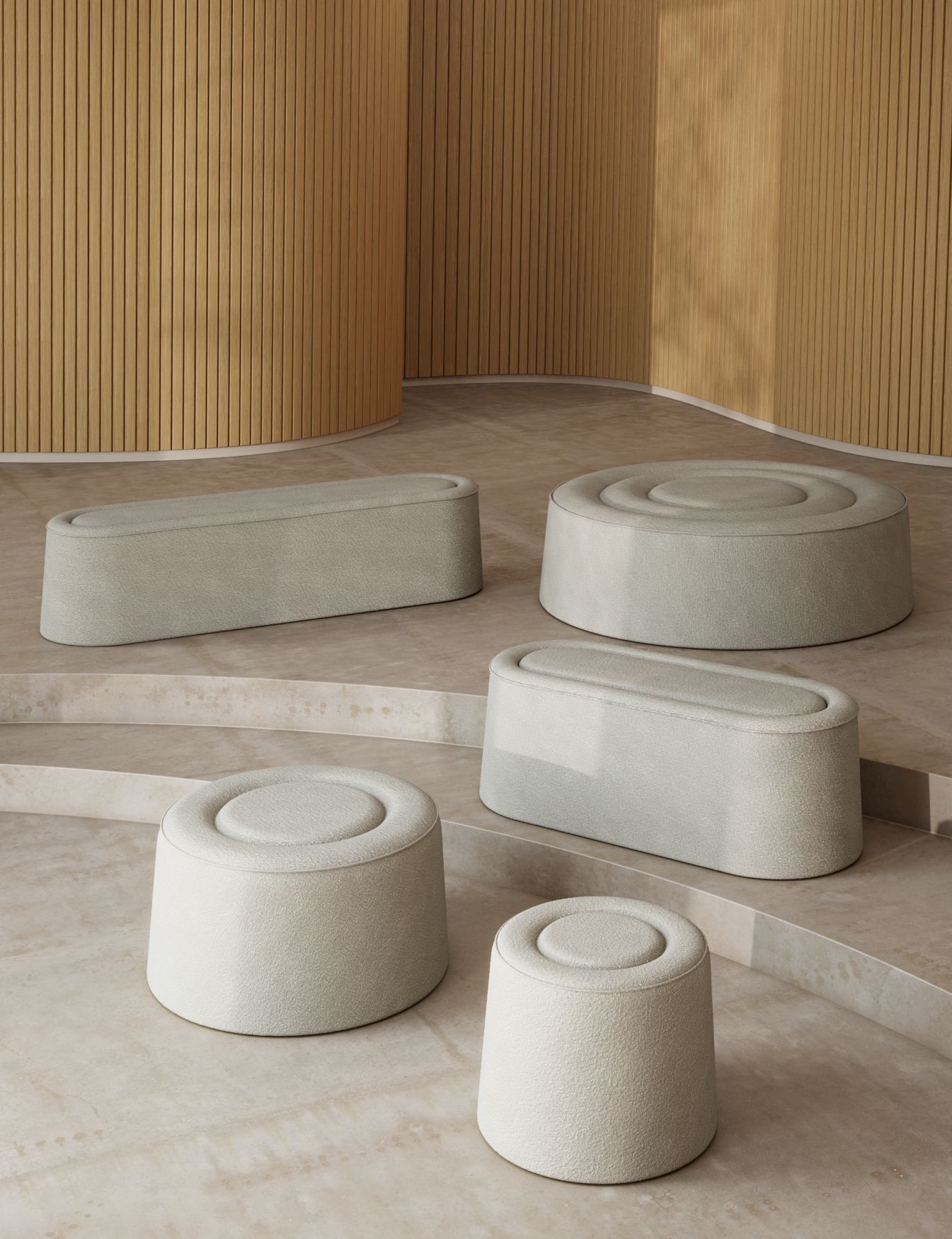 Mehrere graue Praline Hocker von Woud in verschiedenen Formen und Größen auf Podest.