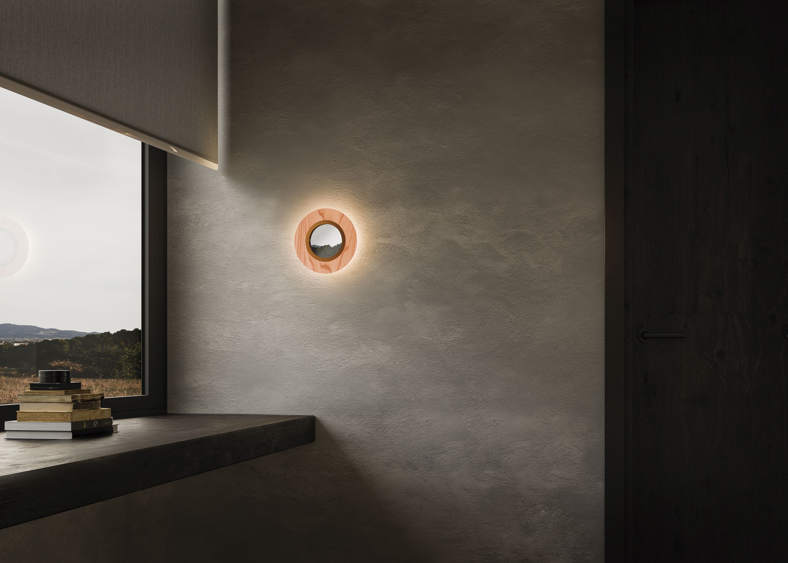 Lens LED Wandleuchte von LZF Lamps, runder Metallring in elfenbeinweiß und hellrosa an Wand.