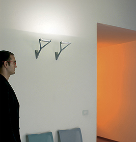 Zwei moderne Luceplan Lola Wandleuchten an einer weißen Wand, indirekte Beleuchtung im Flur.