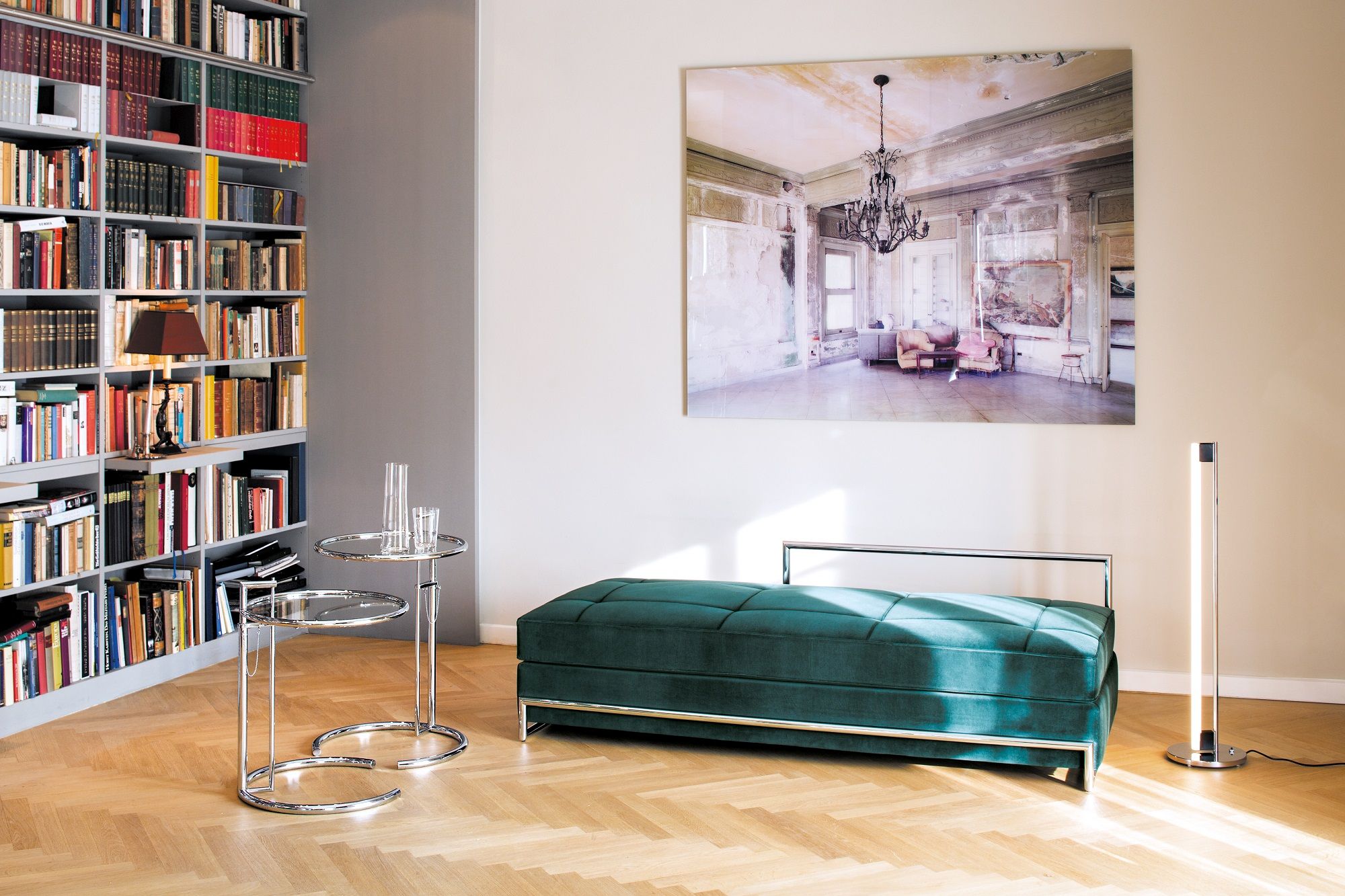 Grüne Classicon Day Bed Liege mit Chromgestell in modernem Wohnzimmer mit Bücherregal.