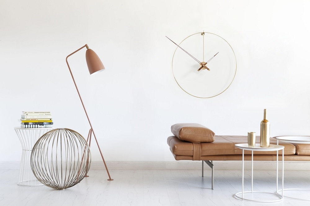 New Anda G Wanduhr von Nomon aus Messing in einem modernen Wohnzimmer mit Designermöbeln.