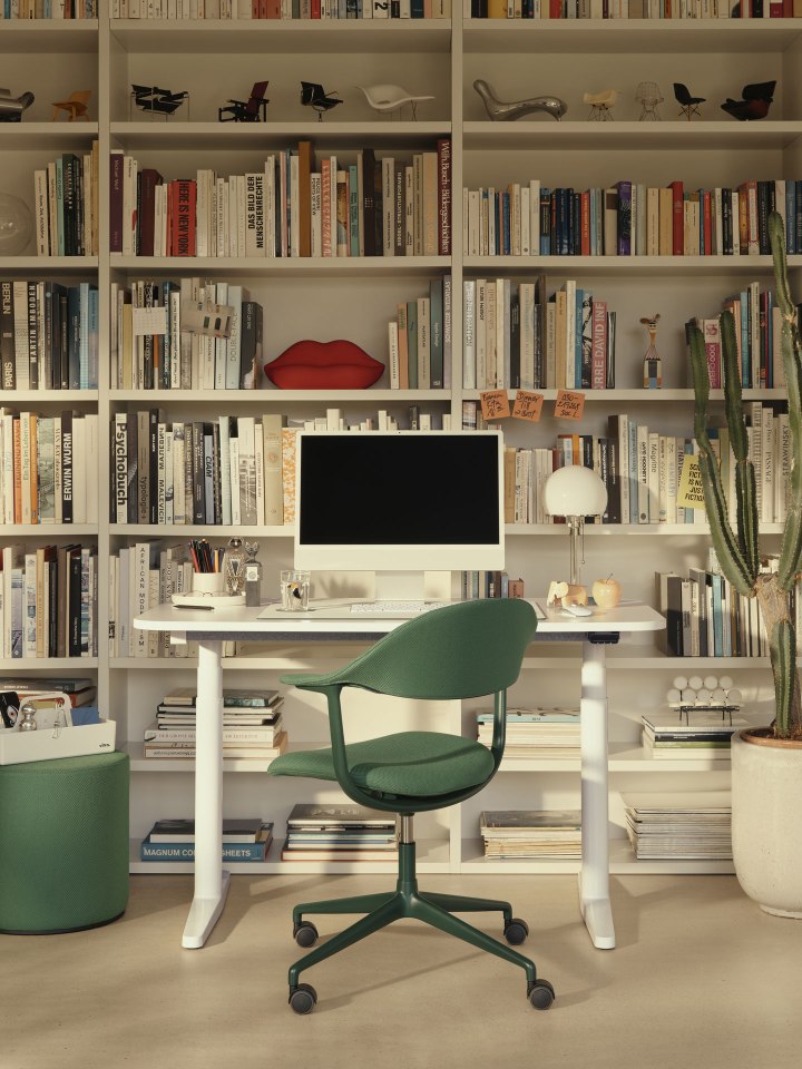 Vitra Tyde 2 Steh-Sitz-Tisch Home Desk Schreibtisch mit grünen Bürostuhl vor Bücherregal.