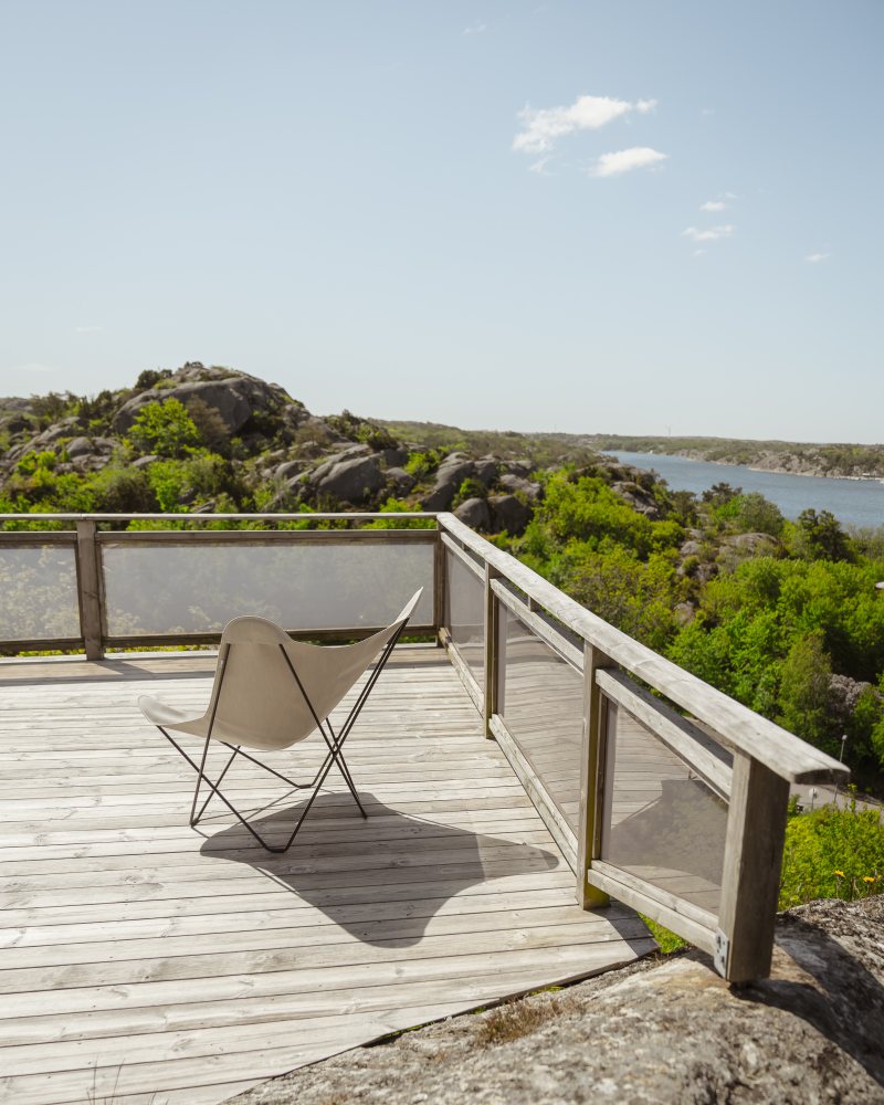Mariposa Butterfly Chair Outdoor Sessel auf Holzterrasse mit Blick auf die Natur.