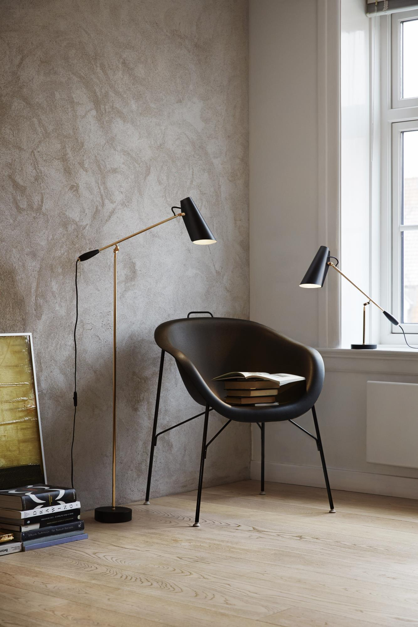 Birdy Stehleuchte und Tischleuchte in Schwarz und Gold im modernen Interieur. Designleuchten für Wohnzimmer.