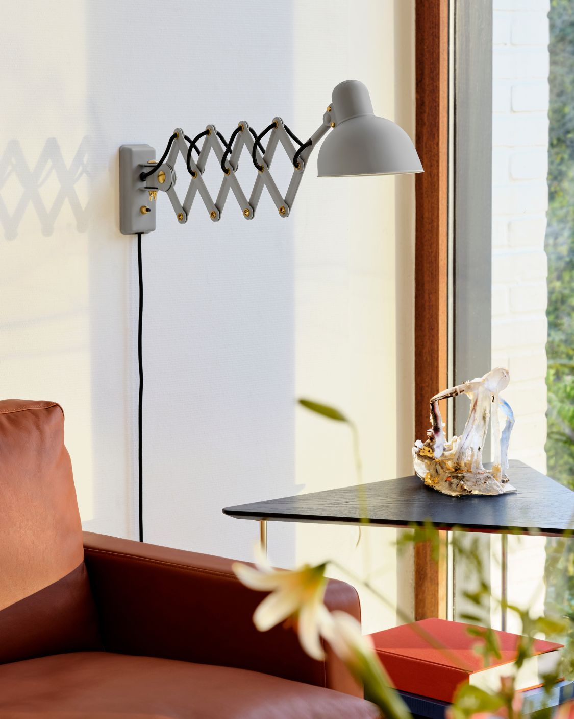 Graue 6718 Scherenleuchte von KAISER idell Fritz Hansen an einer weißen Wand. Designklassiker für Wohnzimmer.