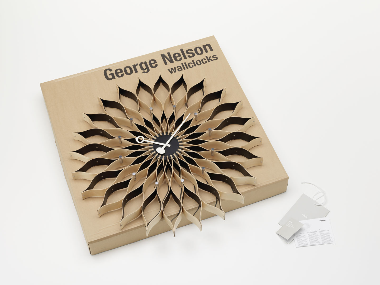 Nahaufnahme der Vitra Sunflower Clock Wanduhr in der Originalverpackung. Design Wanduhr.