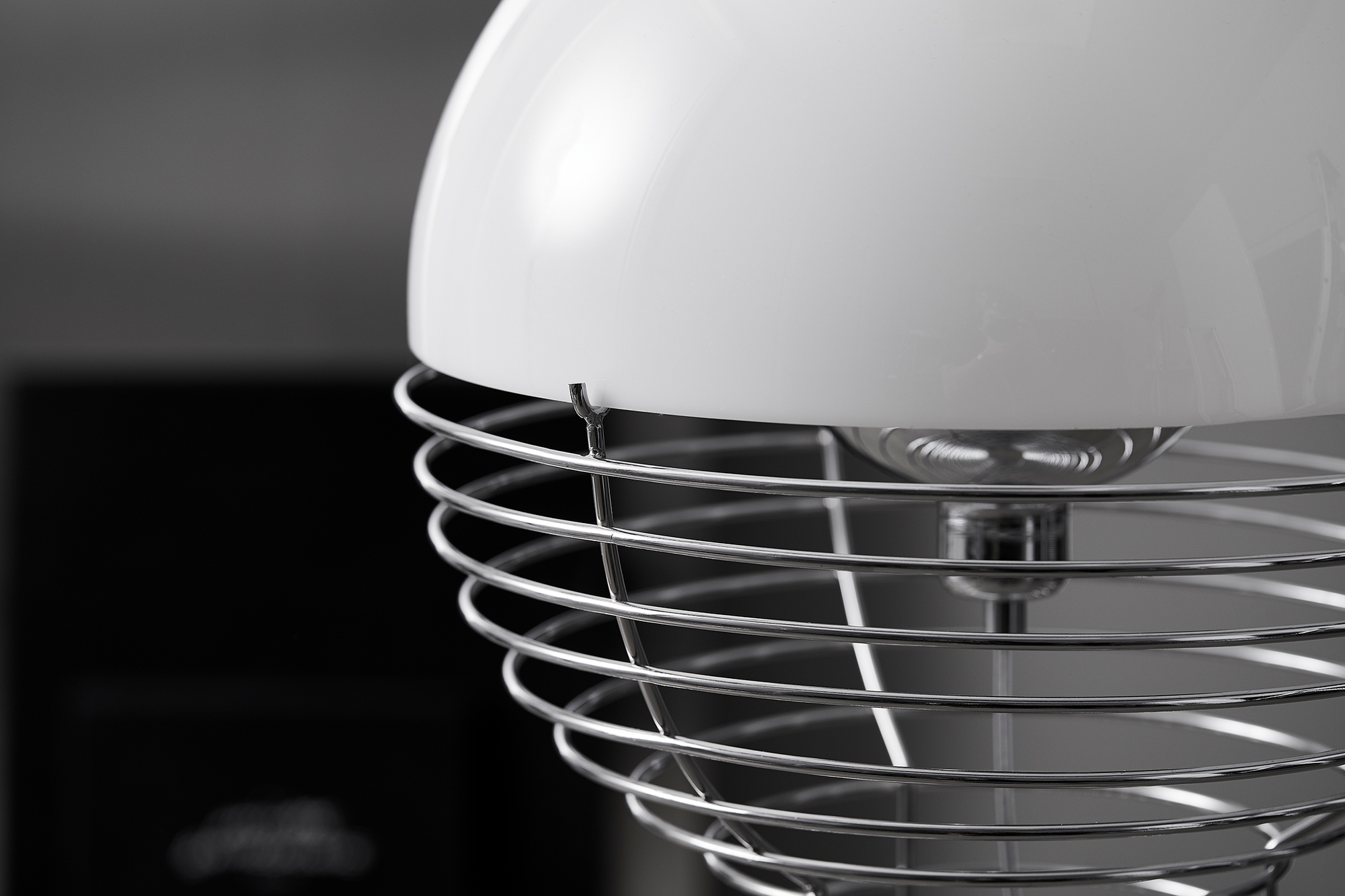 Detailaufnahme der Verpan Wire Stehleuchte mit weißem Schirm und filigranem Drahtgestell aus Chrom.