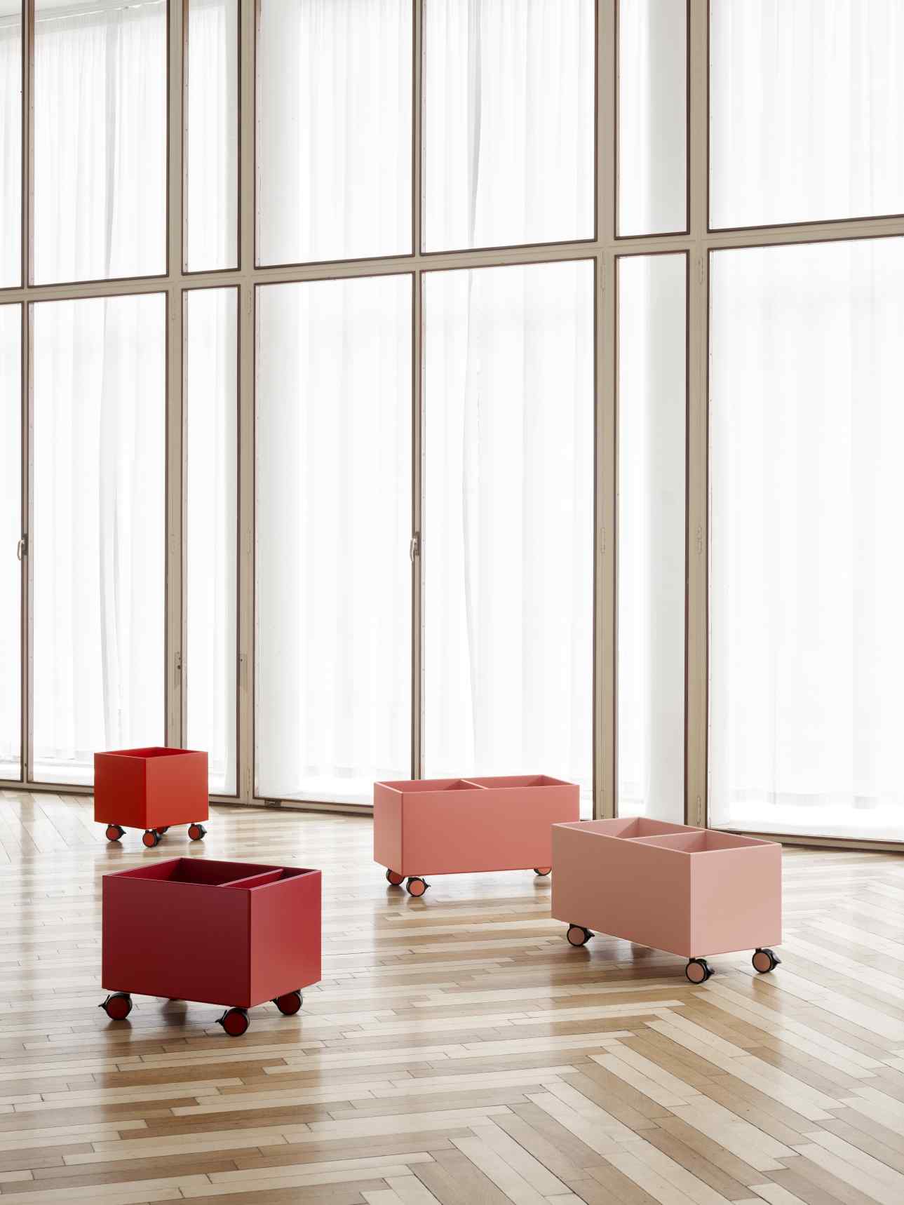 Colour Box Aufbewahrungsboxen auf Rollen in verschiedenen Rottönen für flexible Aufbewahrung im Wohnraum.