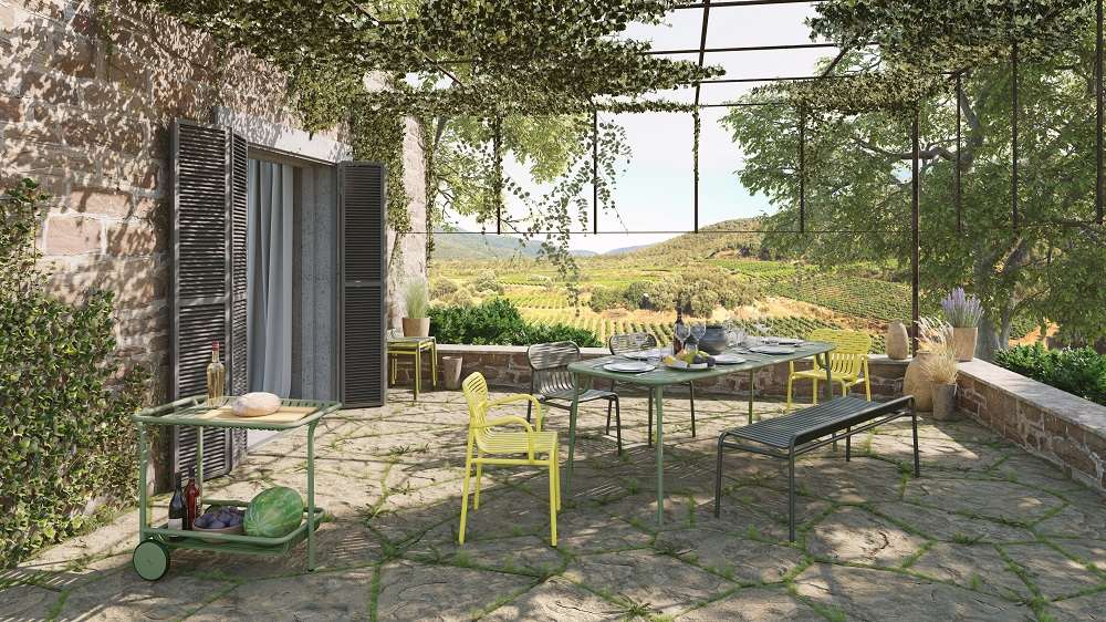 Petite Friture Week-End Rectangle Table in Blau auf einer Terrasse mit Blick auf eine malerische Landschaft.