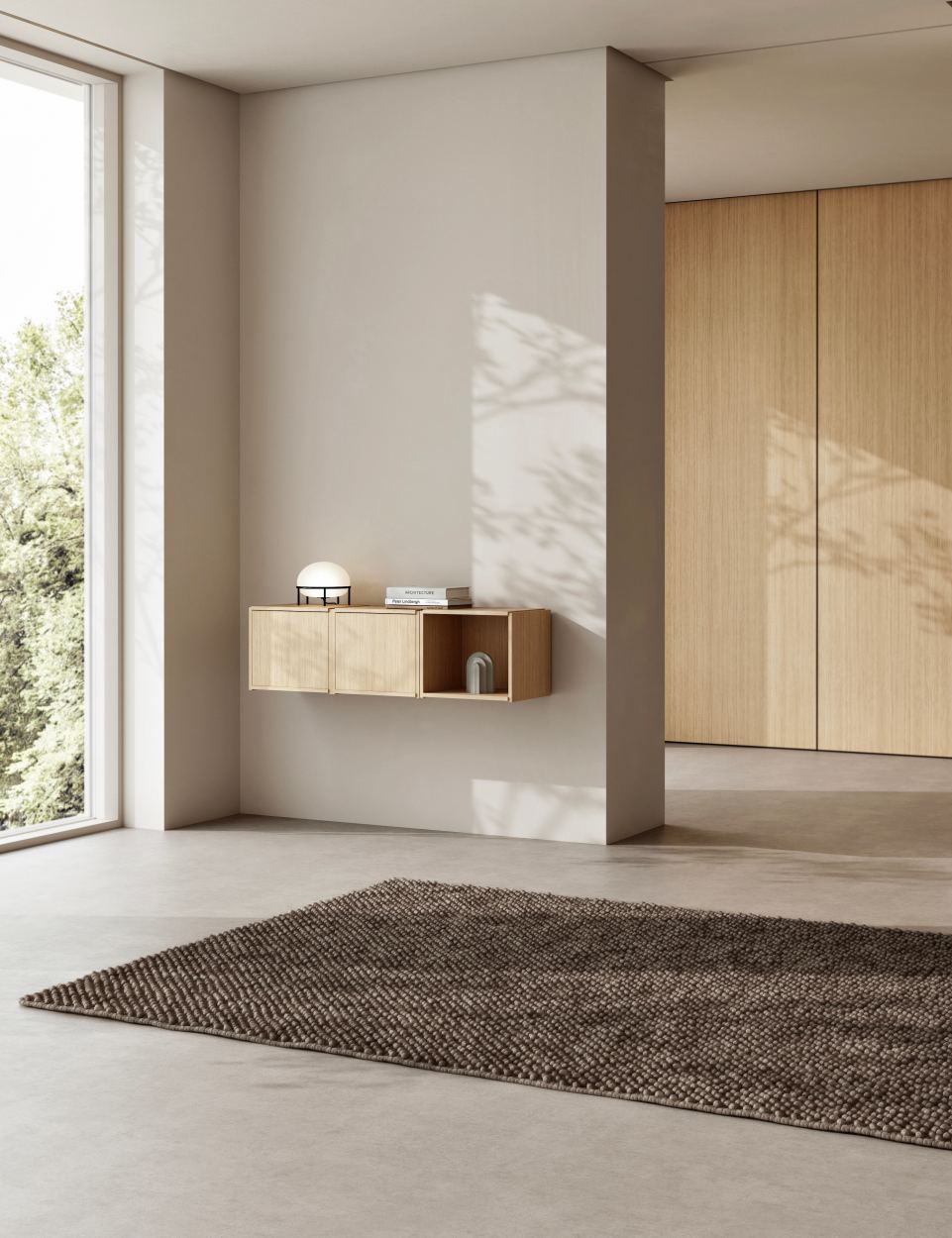 Helles Zimmer mit dem Bricks System Regal von Woud an der Wand.