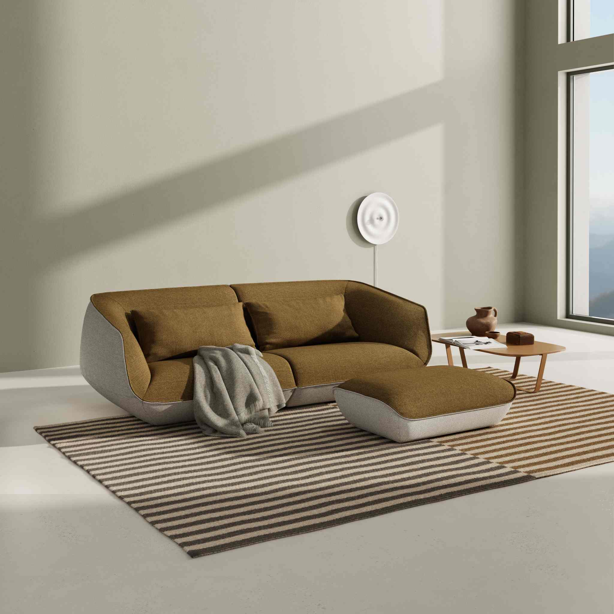 Gemütliches Nook Sofa von Cor in Braun und Grau mit passendem Hocker und Decke.