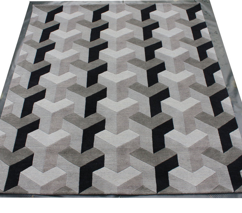 Verner Panton Teppich Ypsilon Wool mit geometrischem 3D-Design in Schwarz, Grau und Beige.