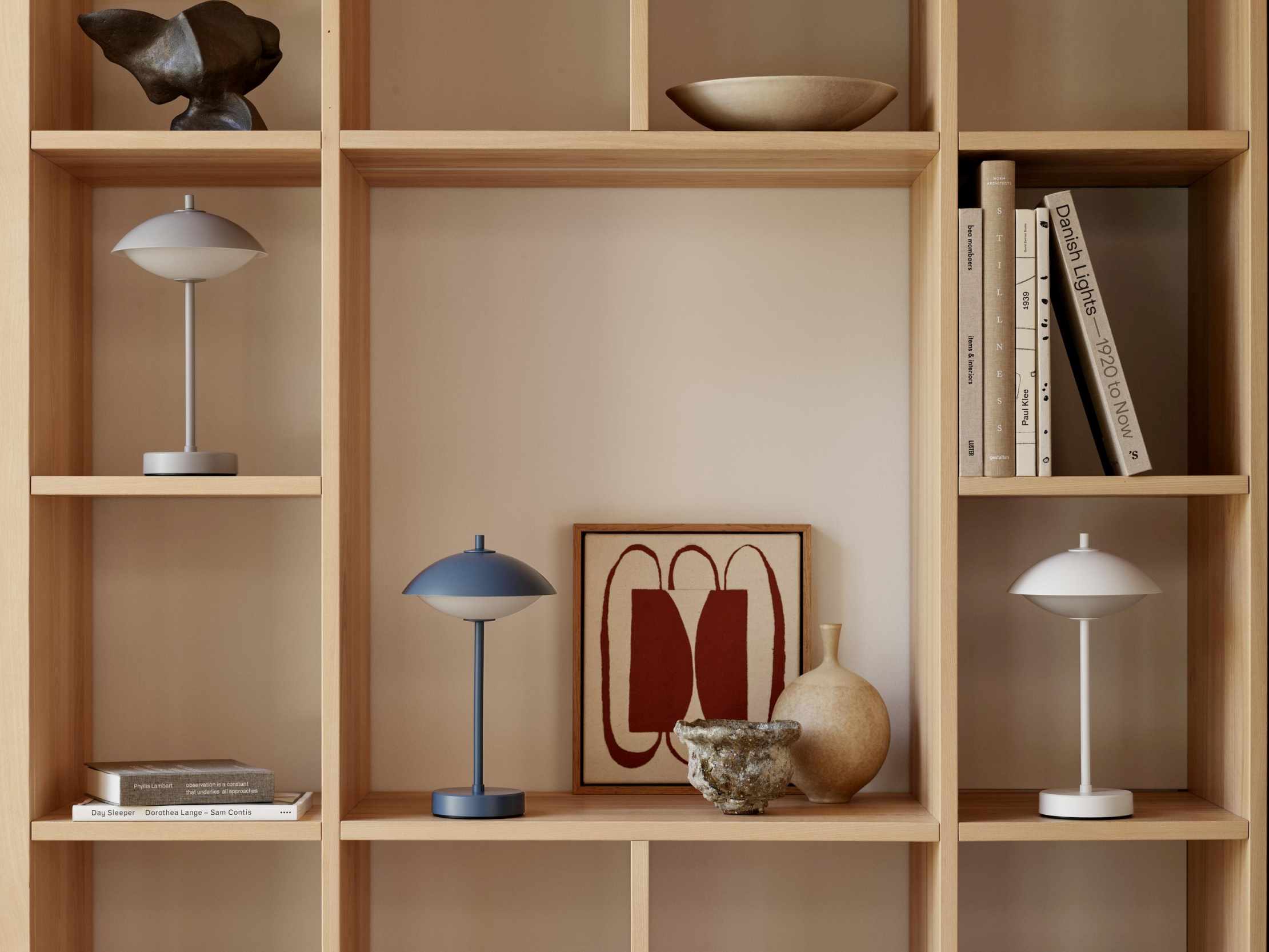 Blau-graue Clam Tischleuchte von Fritz Hansen im Regal, moderne Akkuleuchte für Innenräume.