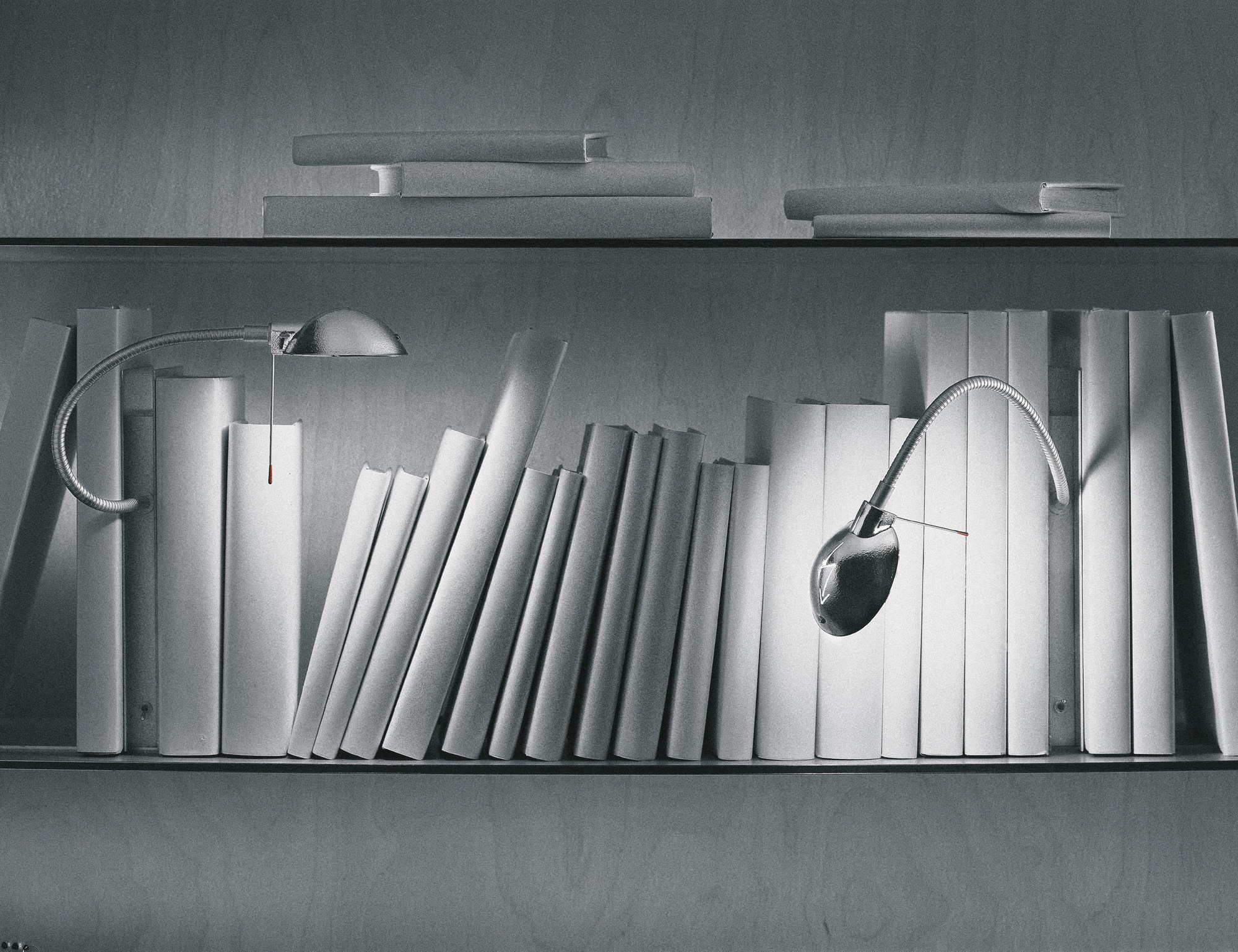 Silberne Oskar Regalleuchte von Ingo Maurer zwischen weißen Büchern im Regal. Designleuchte für Bücherregale.