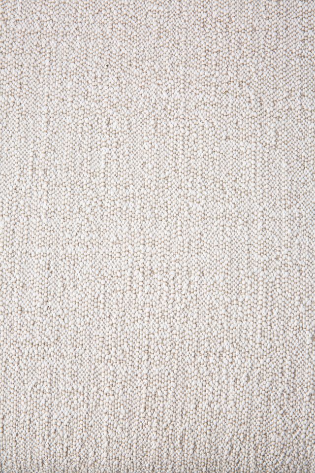 Detailaufnahme des beigen Stoffbezugs vom Jack Outdoor Polsterhocker von Ethnicraft. Nahaufnahme der Textur.