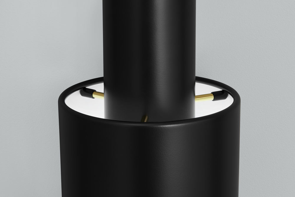 Detailaufnahme der schwarzen A110 Pendelleuchte von Artek, modernes Design mit goldenen Akzenten.