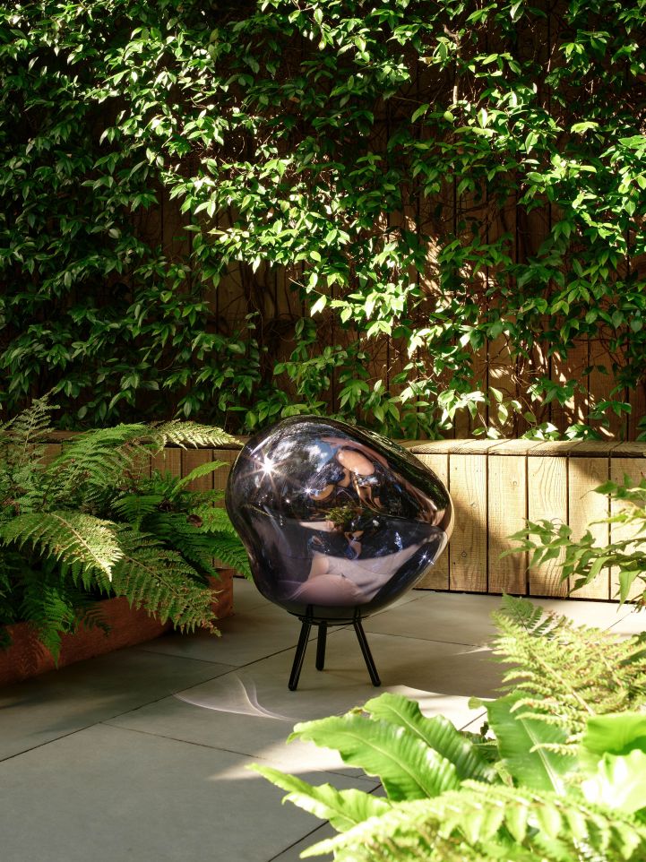 Goldene Melt LED Leuchte von Tom Dixon als Bodenleuchte im Garten.