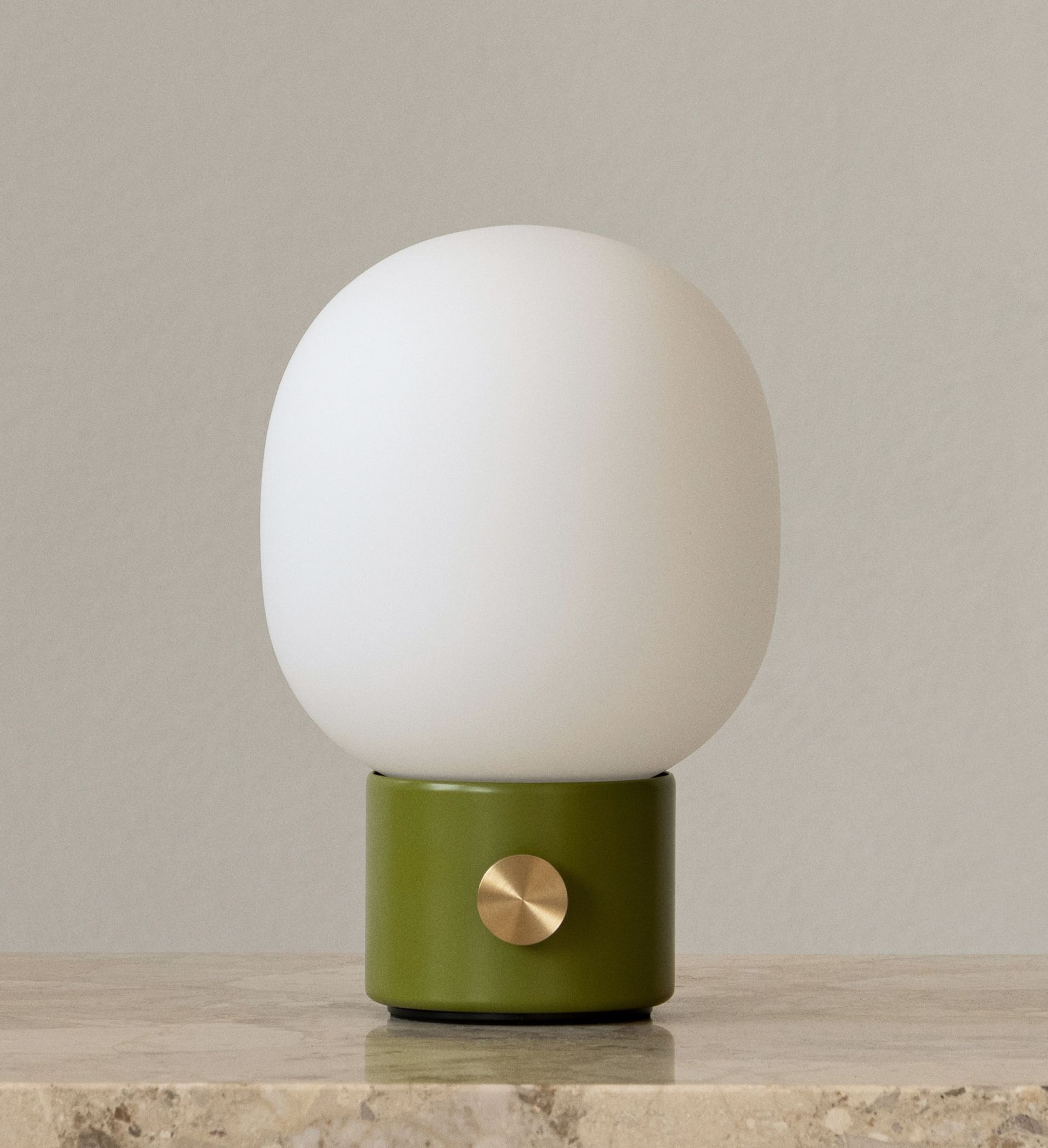 JWDA Tischleuchte in Staubgrün: Tragbare Lampe mit weißem Glas und Messingdetail.