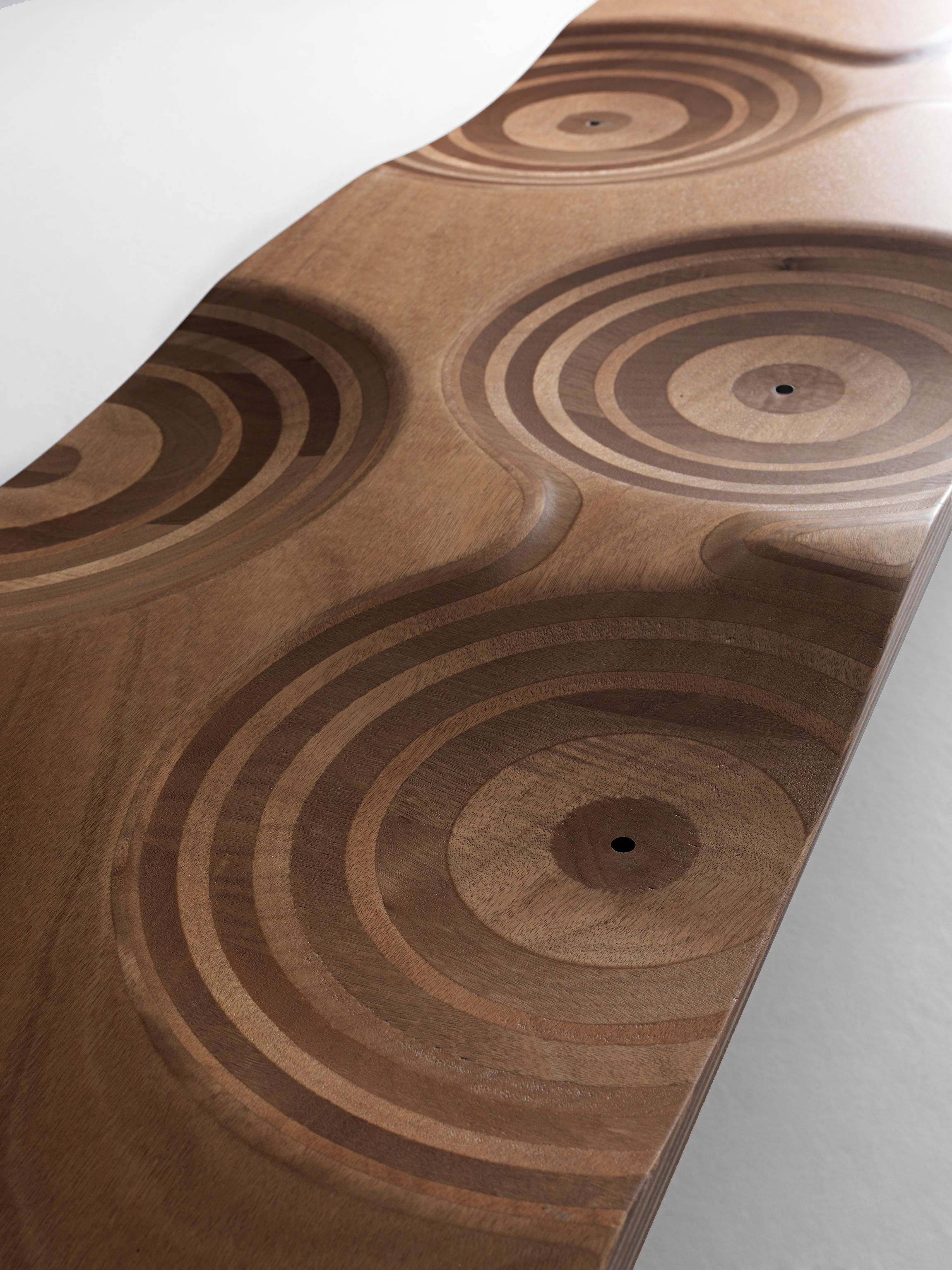 Detailaufnahme der Ripples Bank von Casamania Horm mit konzentrischen Kreisen im Holz.