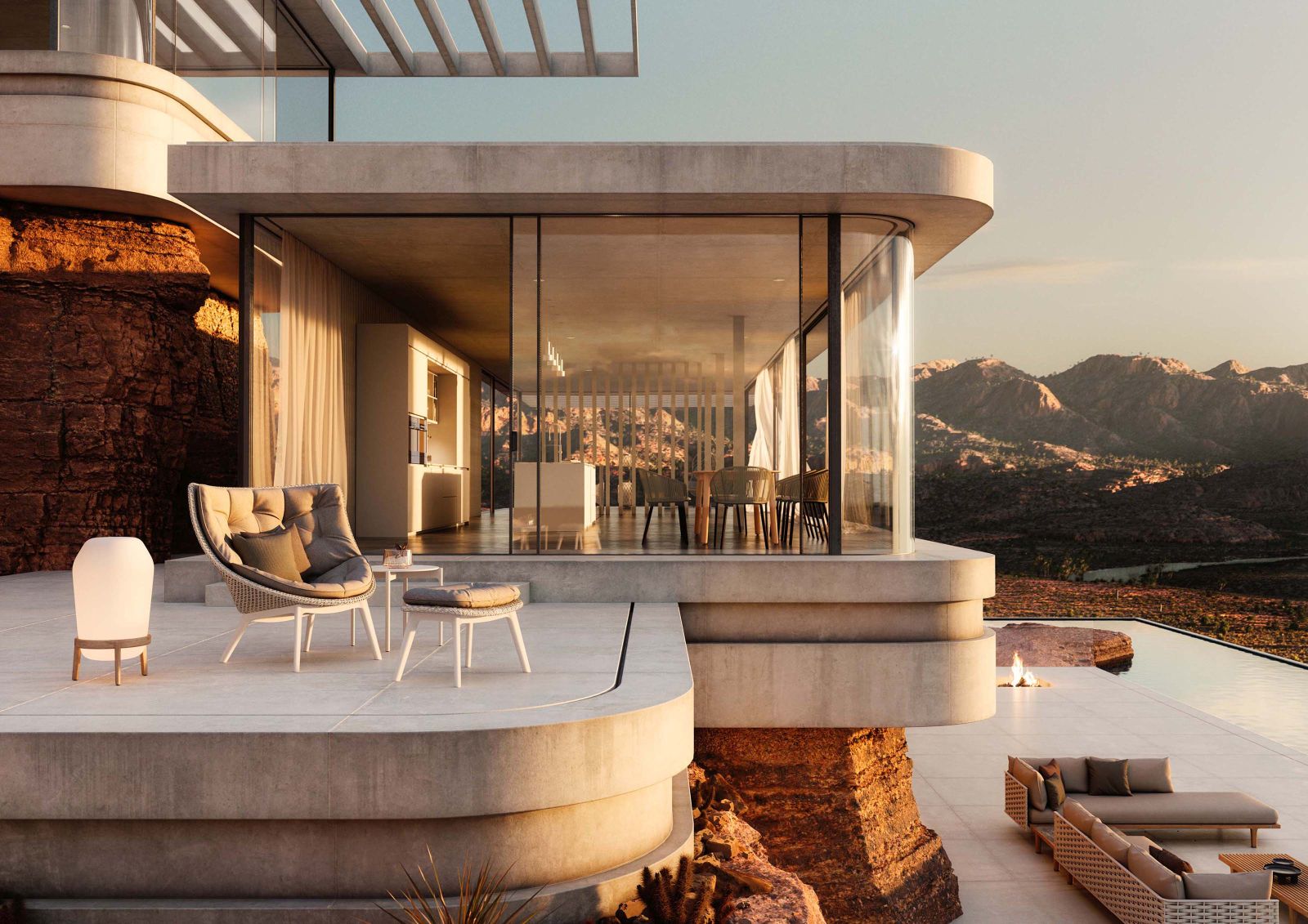 Mbrace Alu Lounge Sessel von Dedon mit Sitzkissen auf Terrasse mit Panoramablick.